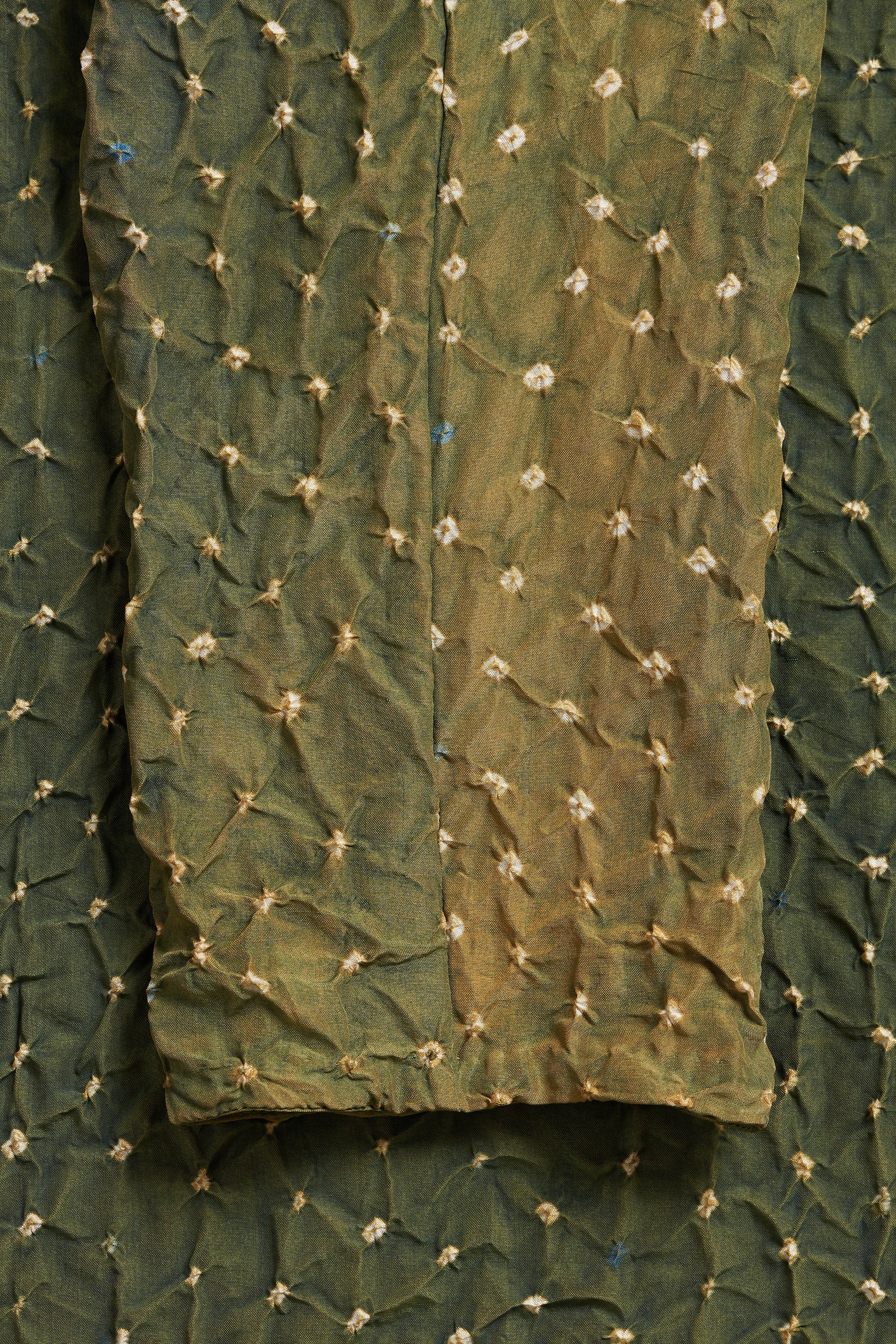 Green fabric with floral embroidery