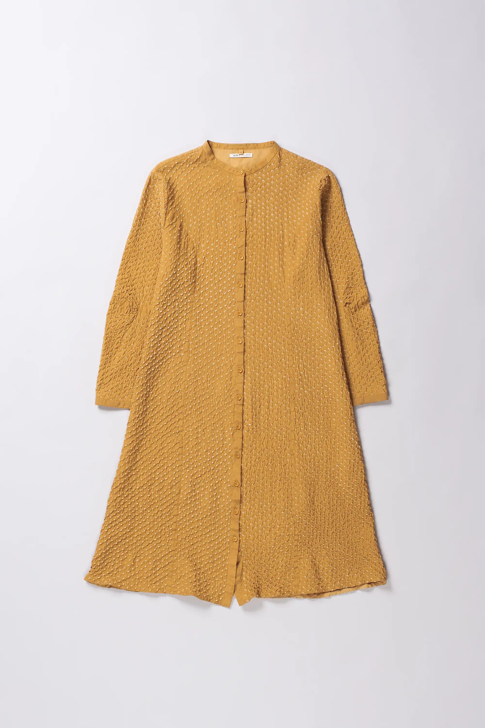 Mustard yellow textured dress on a white background