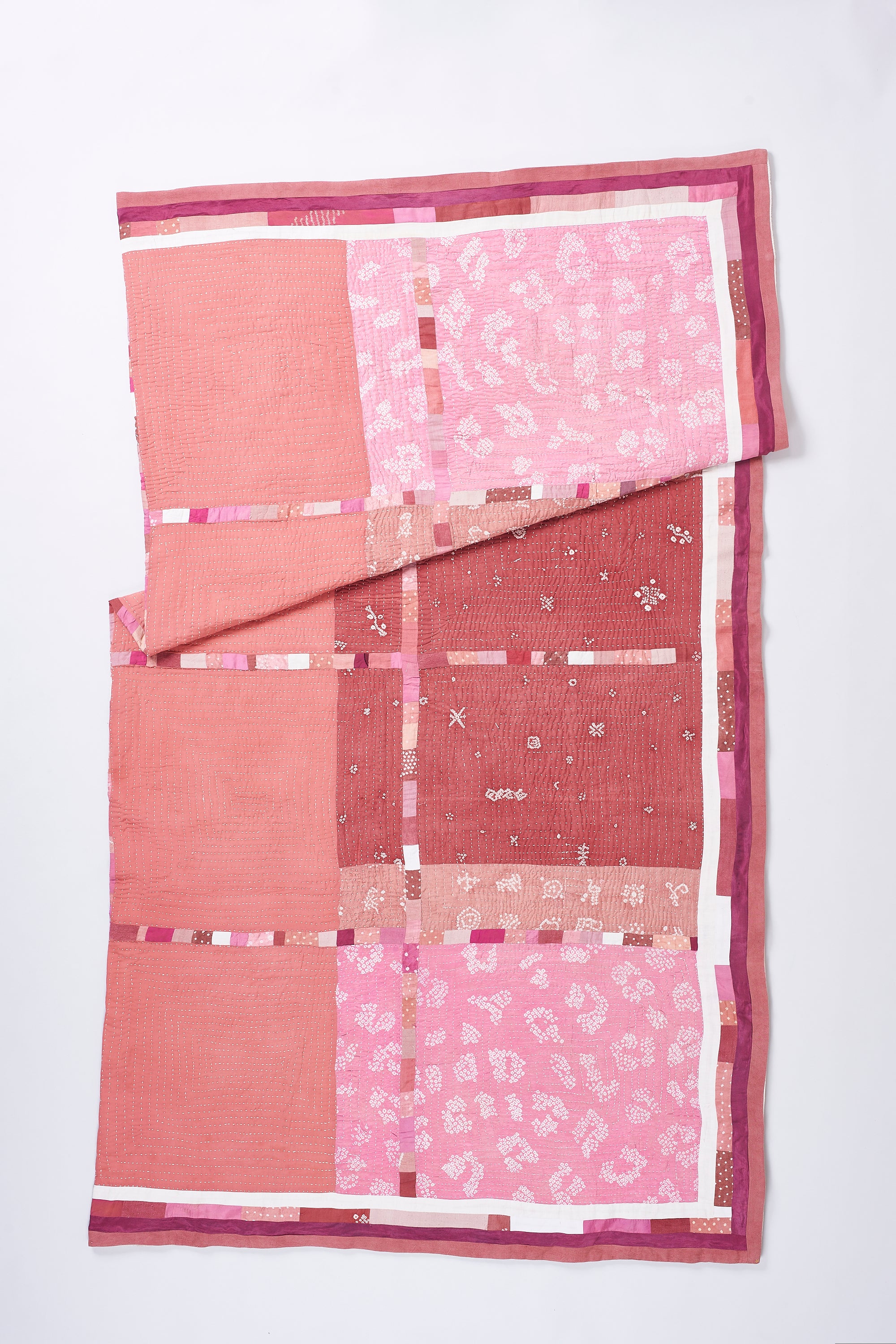 HAND EMBROIDERED PATCHWORK QUILT IN PINK WOOD