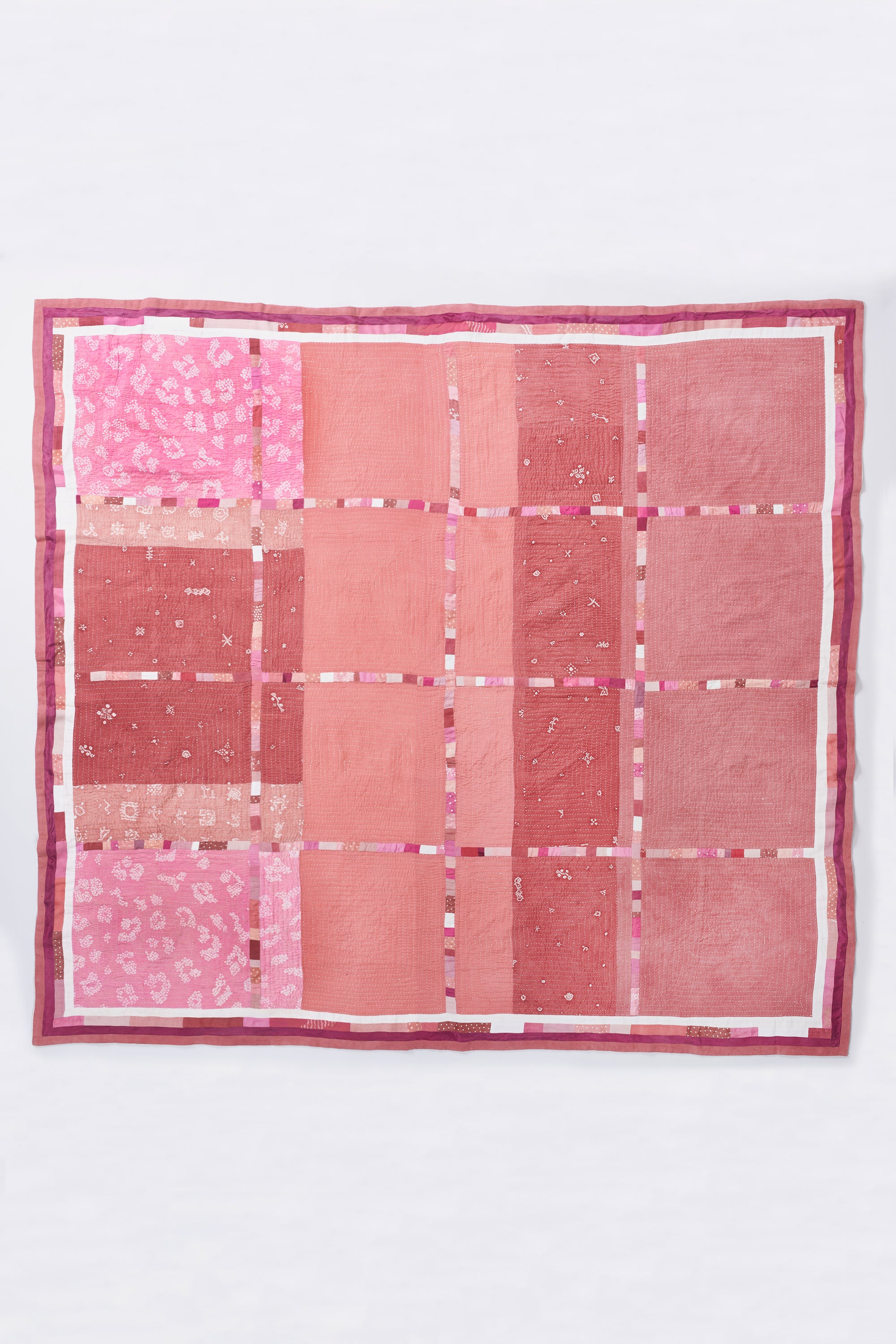 HAND EMBROIDERED PATCHWORK QUILT IN PINK WOOD