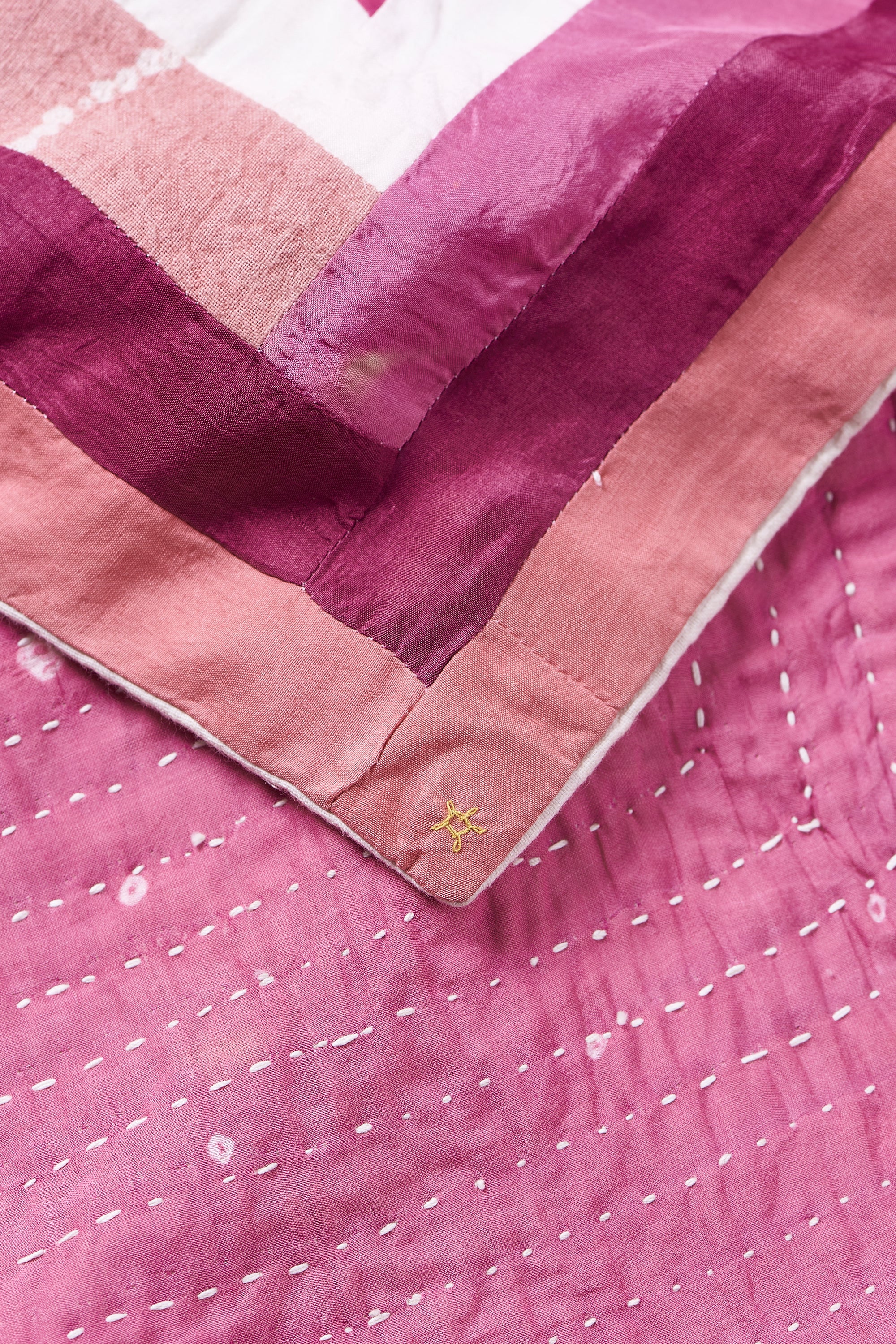 HAND EMBROIDERED PATCHWORK QUILT IN PINK WOOD
