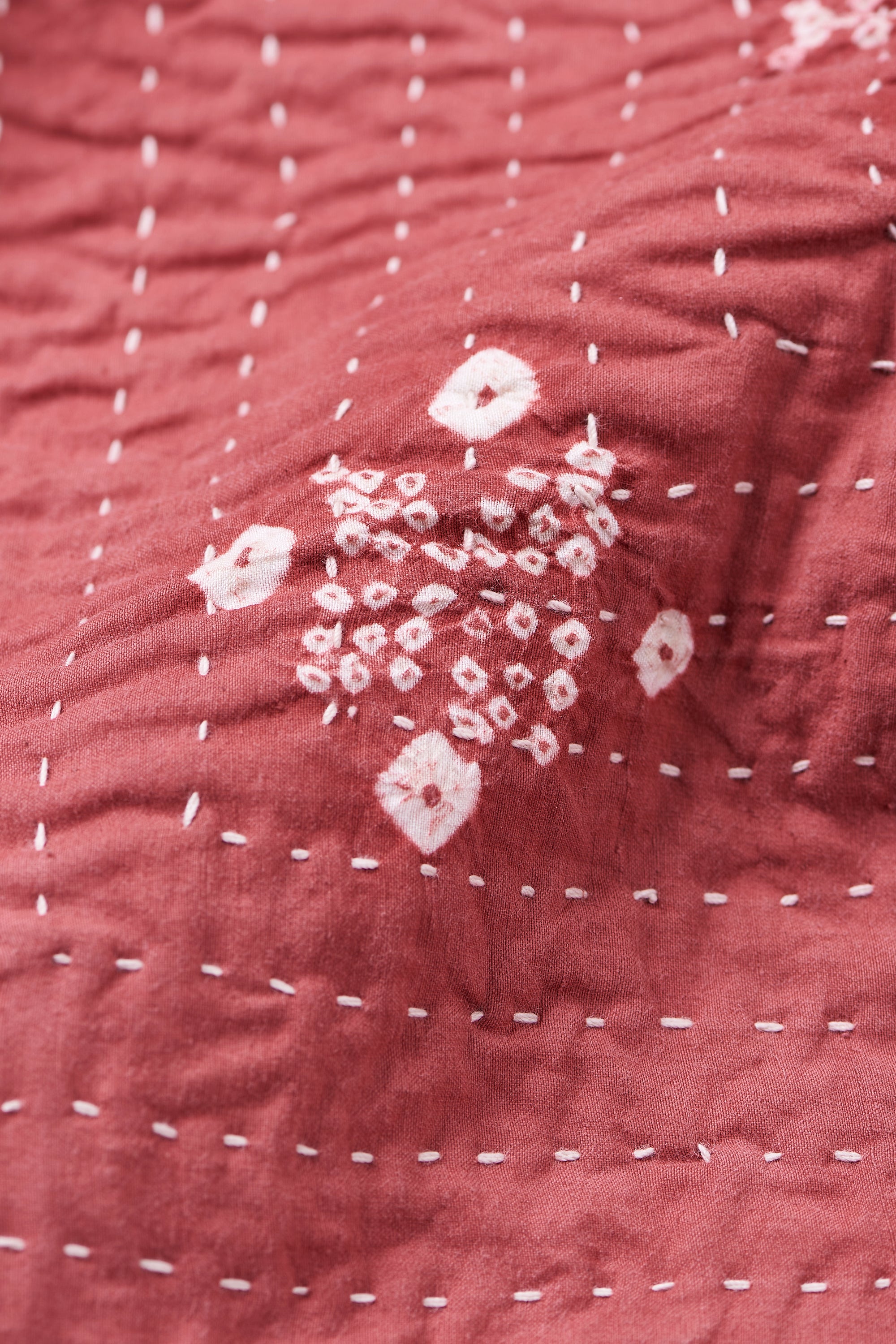 HAND EMBROIDERED PATCHWORK QUILT IN PINK WOOD