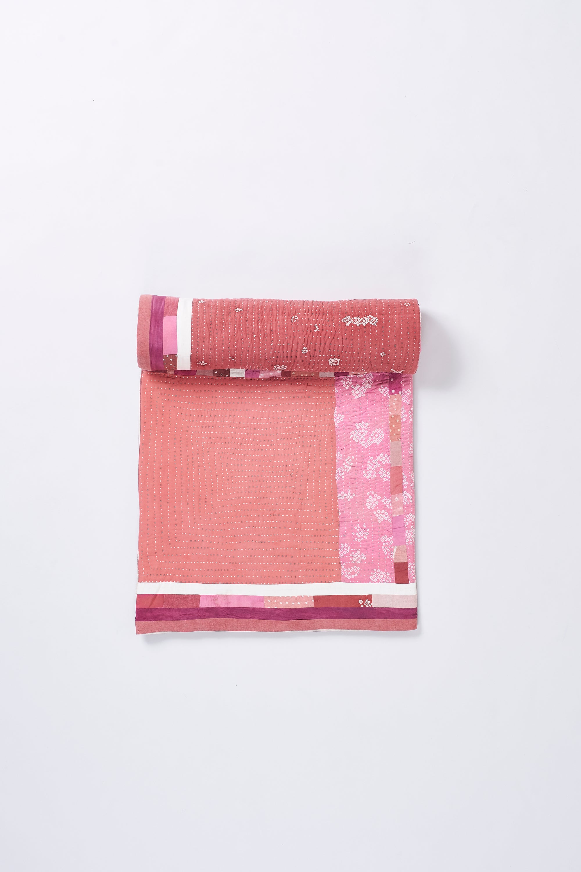 HAND EMBROIDERED PATCHWORK QUILT IN PINK WOOD