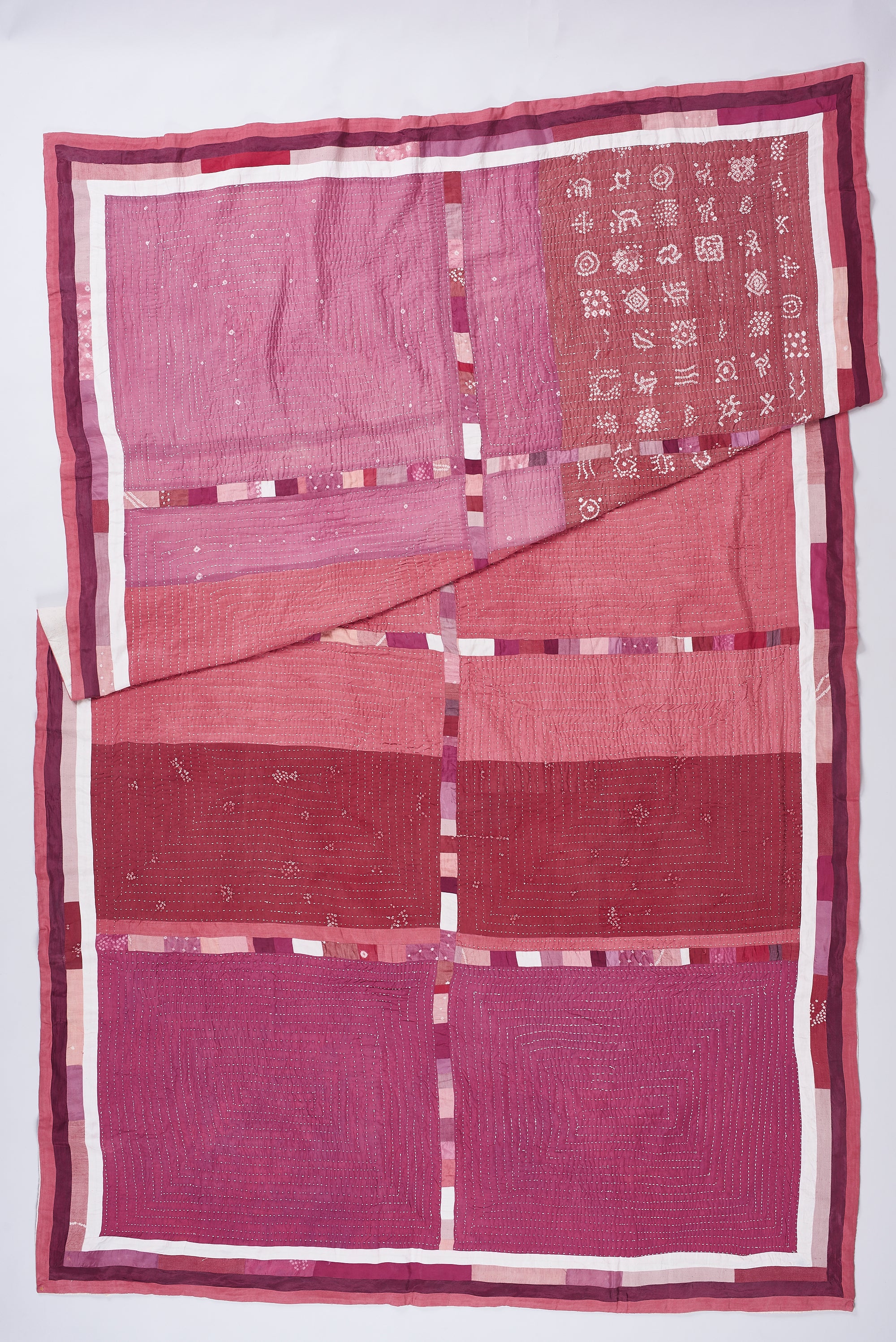 HAND EMBROIDERED PATCHWORK QUILT IN PINK WOOD