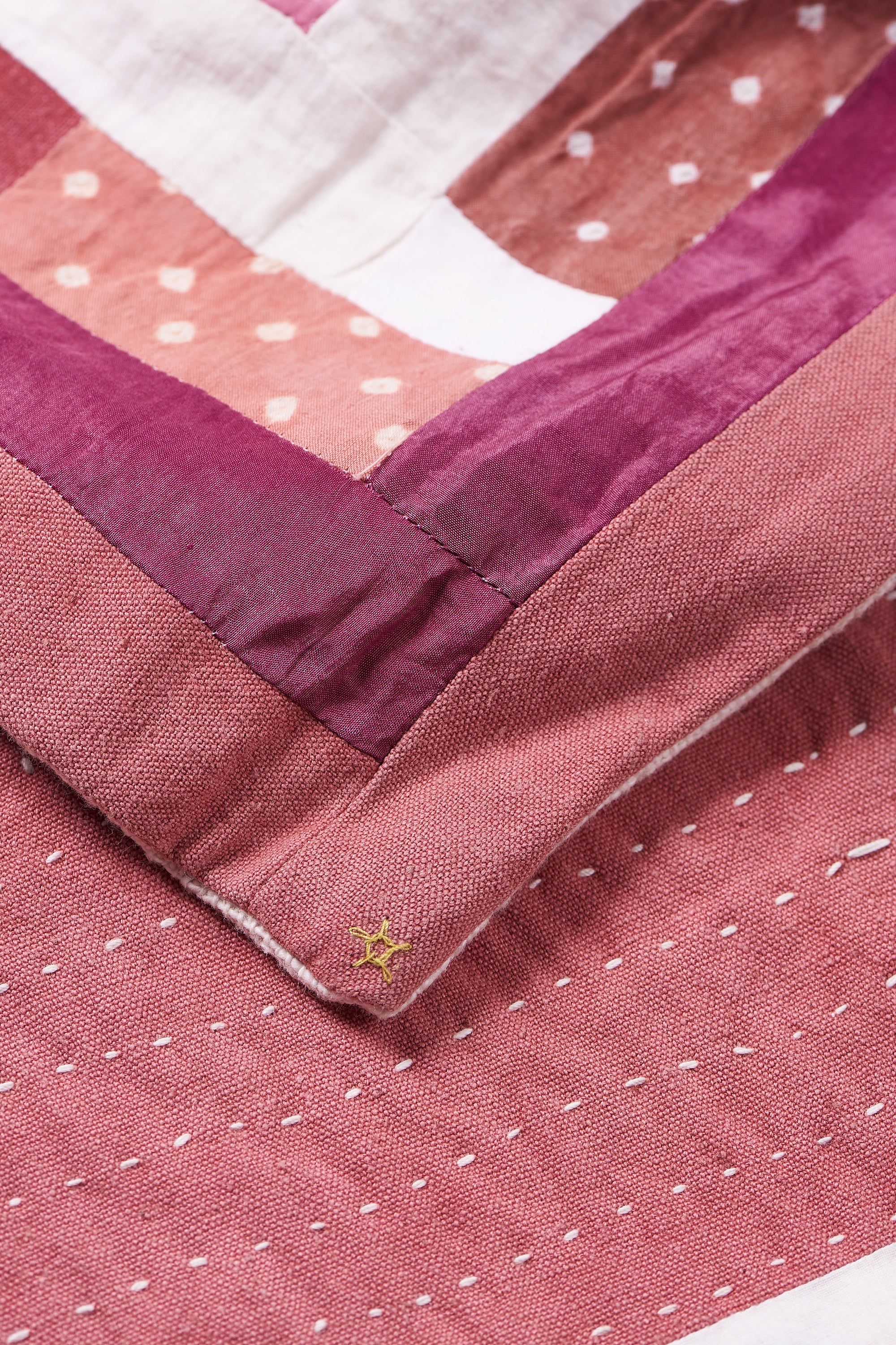 HAND EMBROIDERED PATCHWORK QUILT IN PINK WOOD
