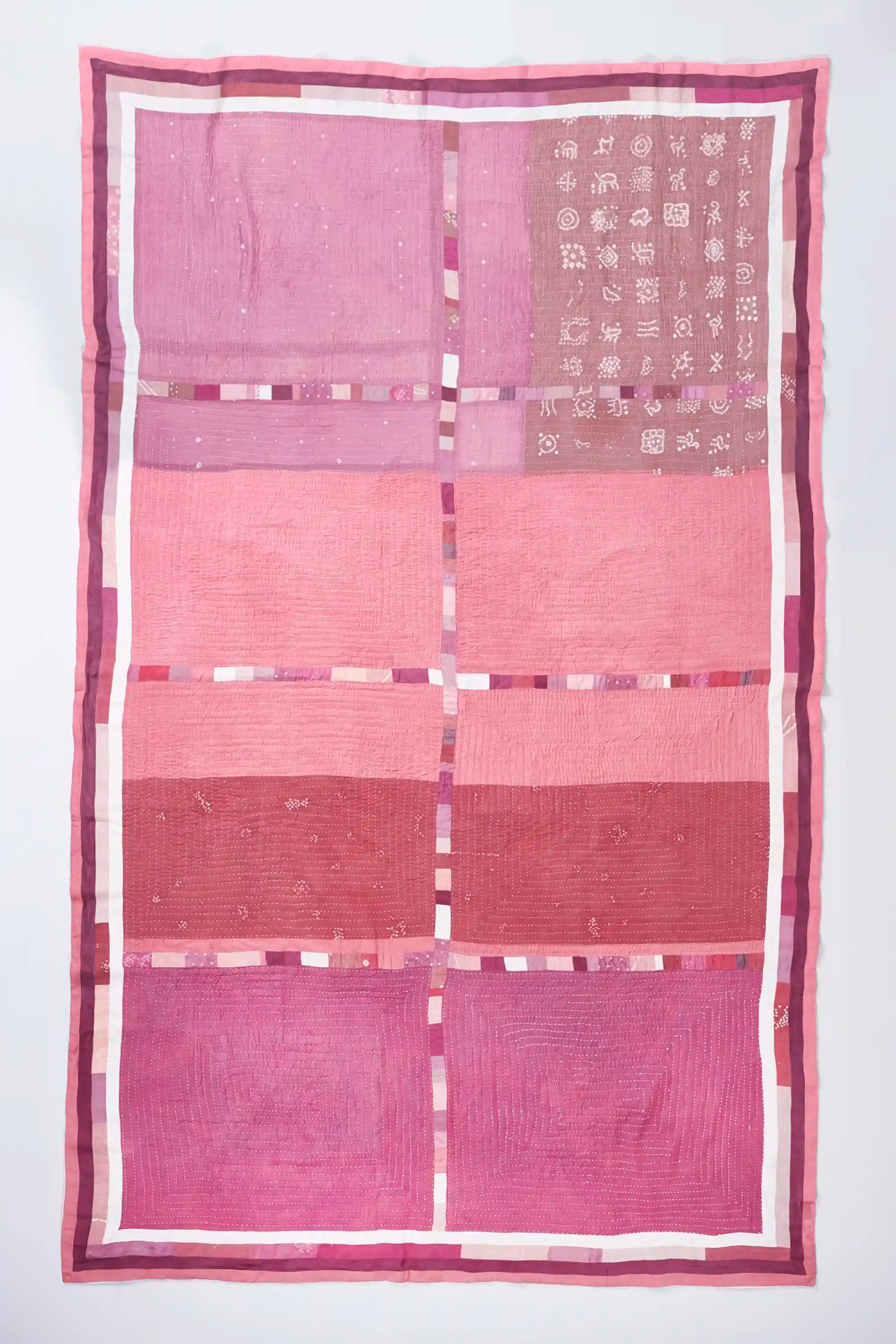 Hand work quilt in shades of pink