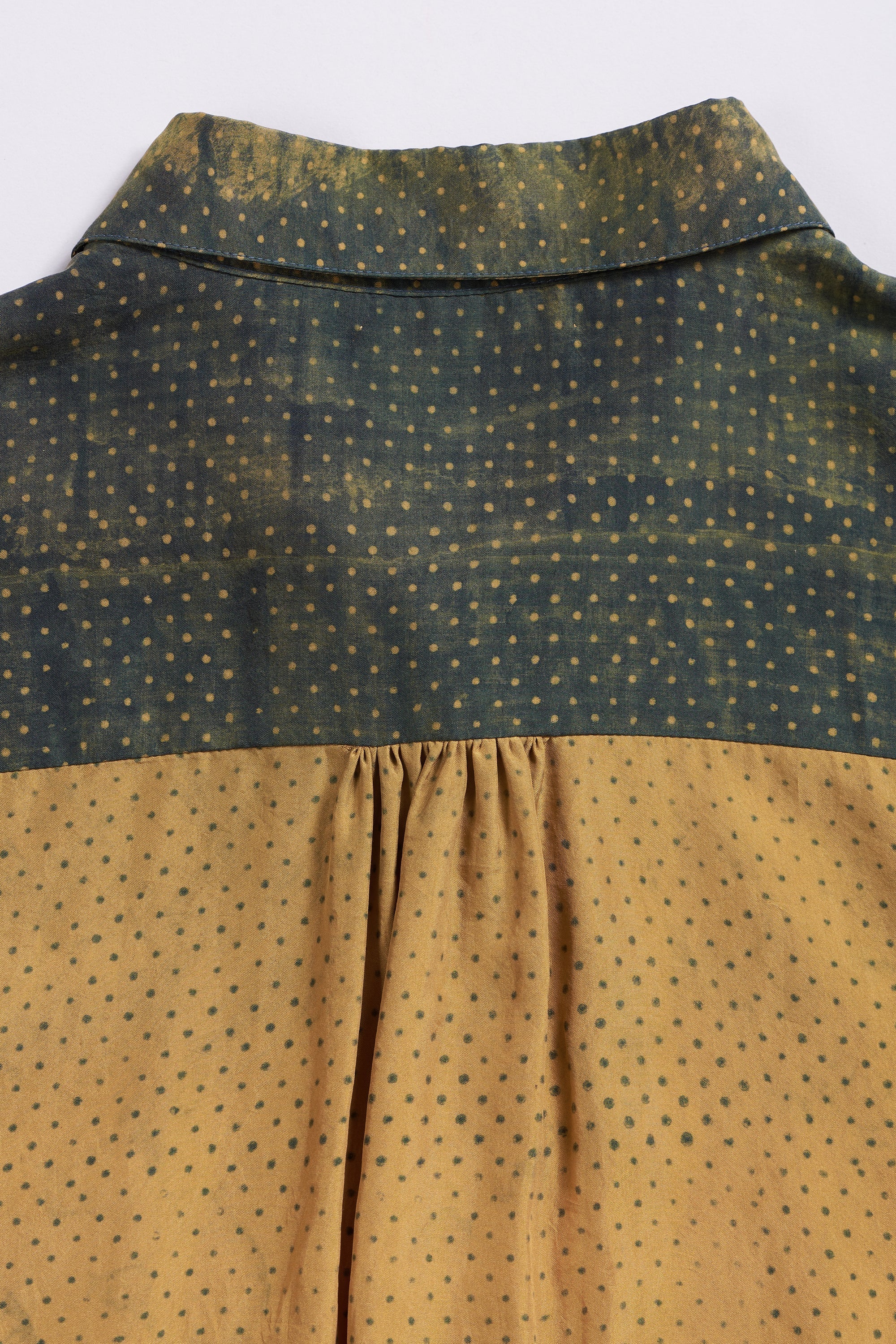 Close-up of a shirt with green and brown patterned fabric