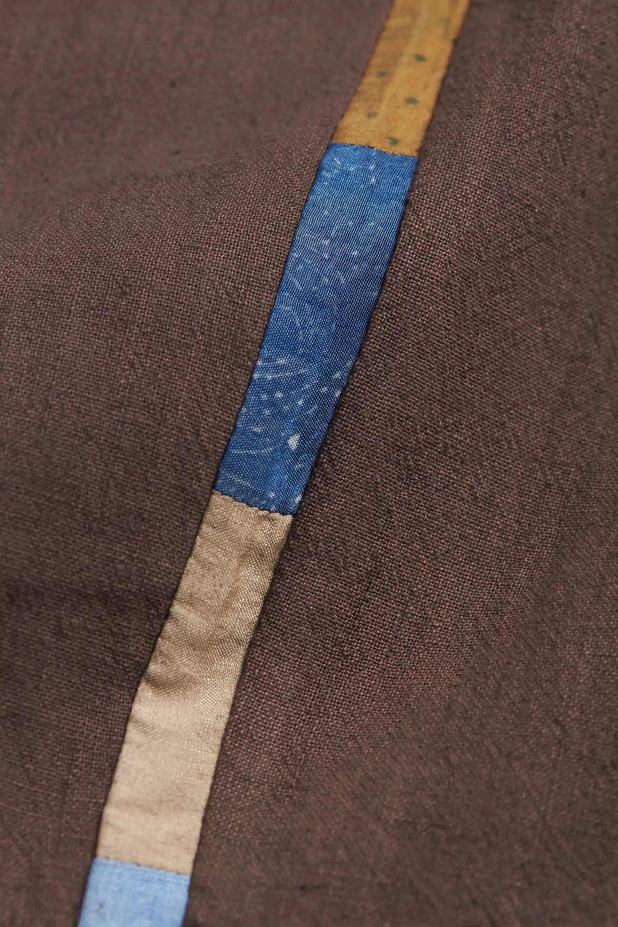 Close-up of fabric with a blue and beige stripe patchwork