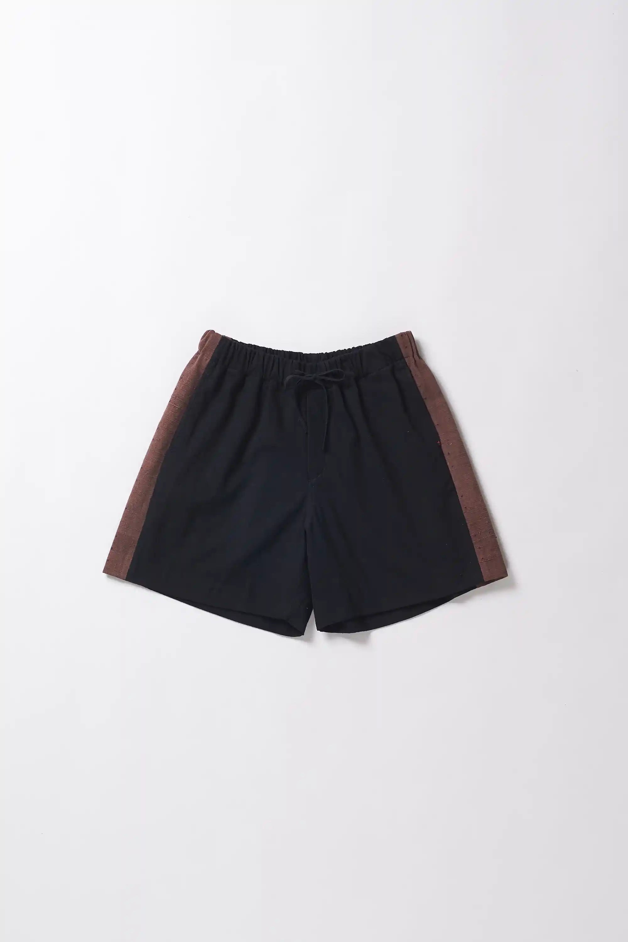 Black shorts with brown accents on a grey background