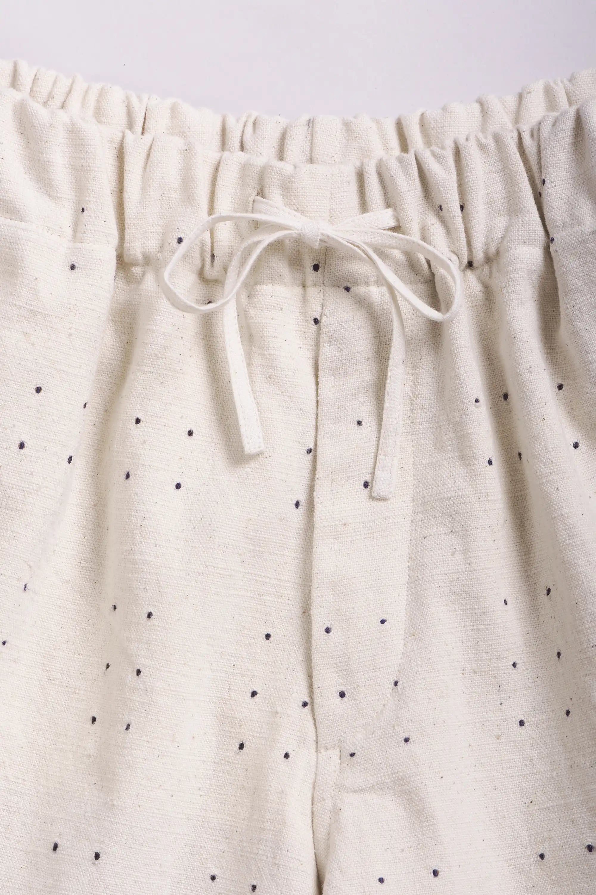 Close-up of a pants with drawstring a light grey background