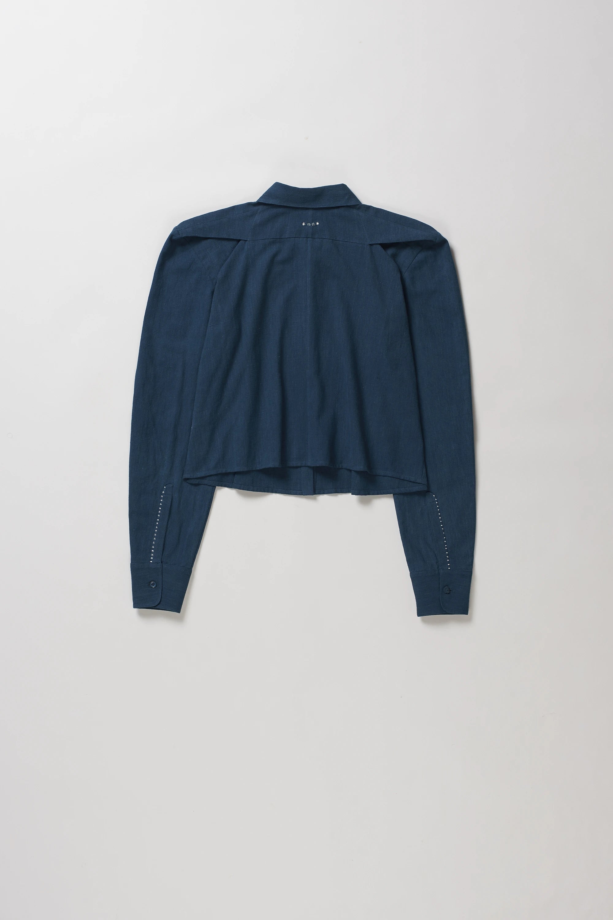 A space blue cropped long-sleeve shirt with a high collar, shown from the back against a light grey background.