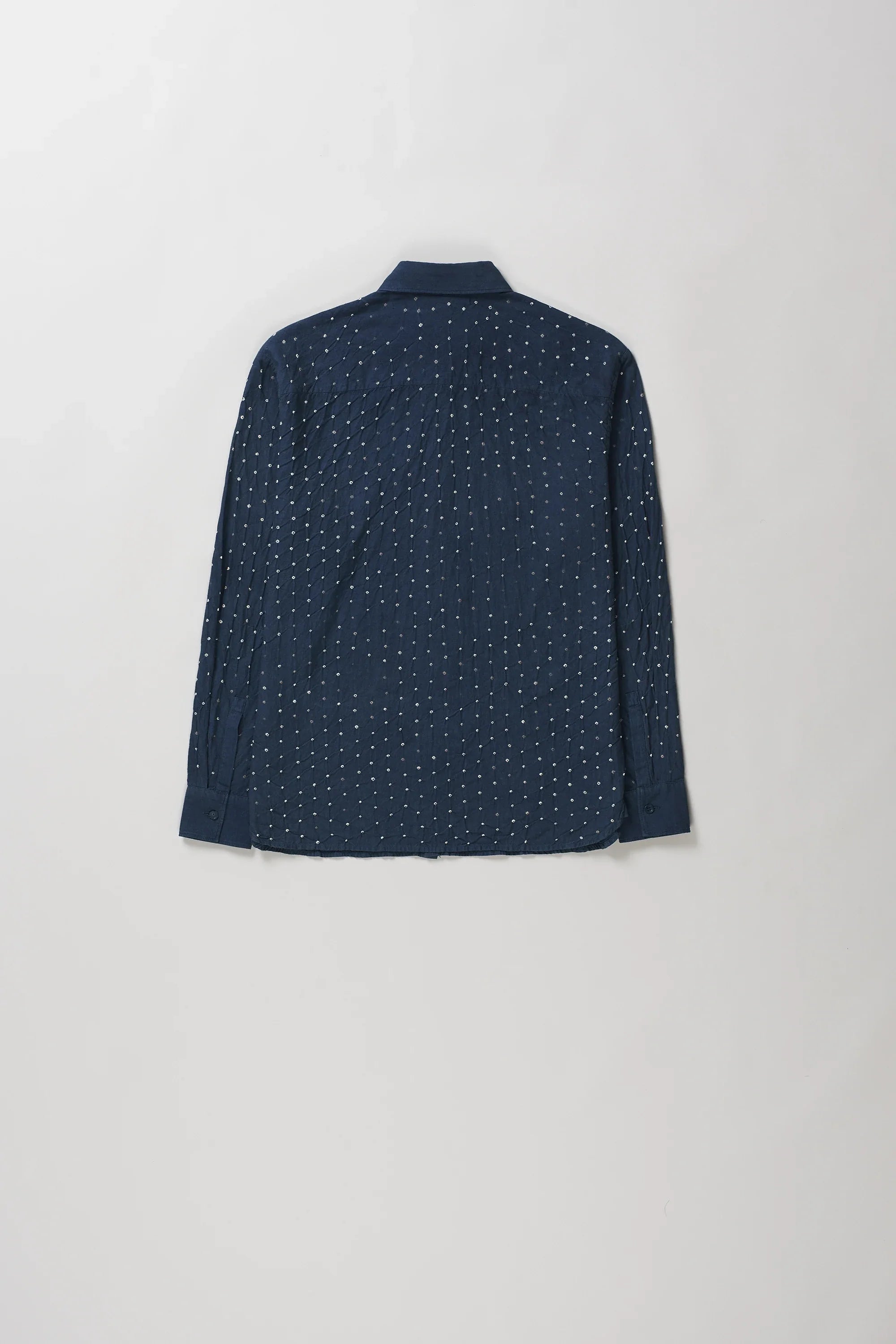 Back shot of space blue long-sleeve button-up shirt with a fine white dotted pattern, laid flat against a light grey background.