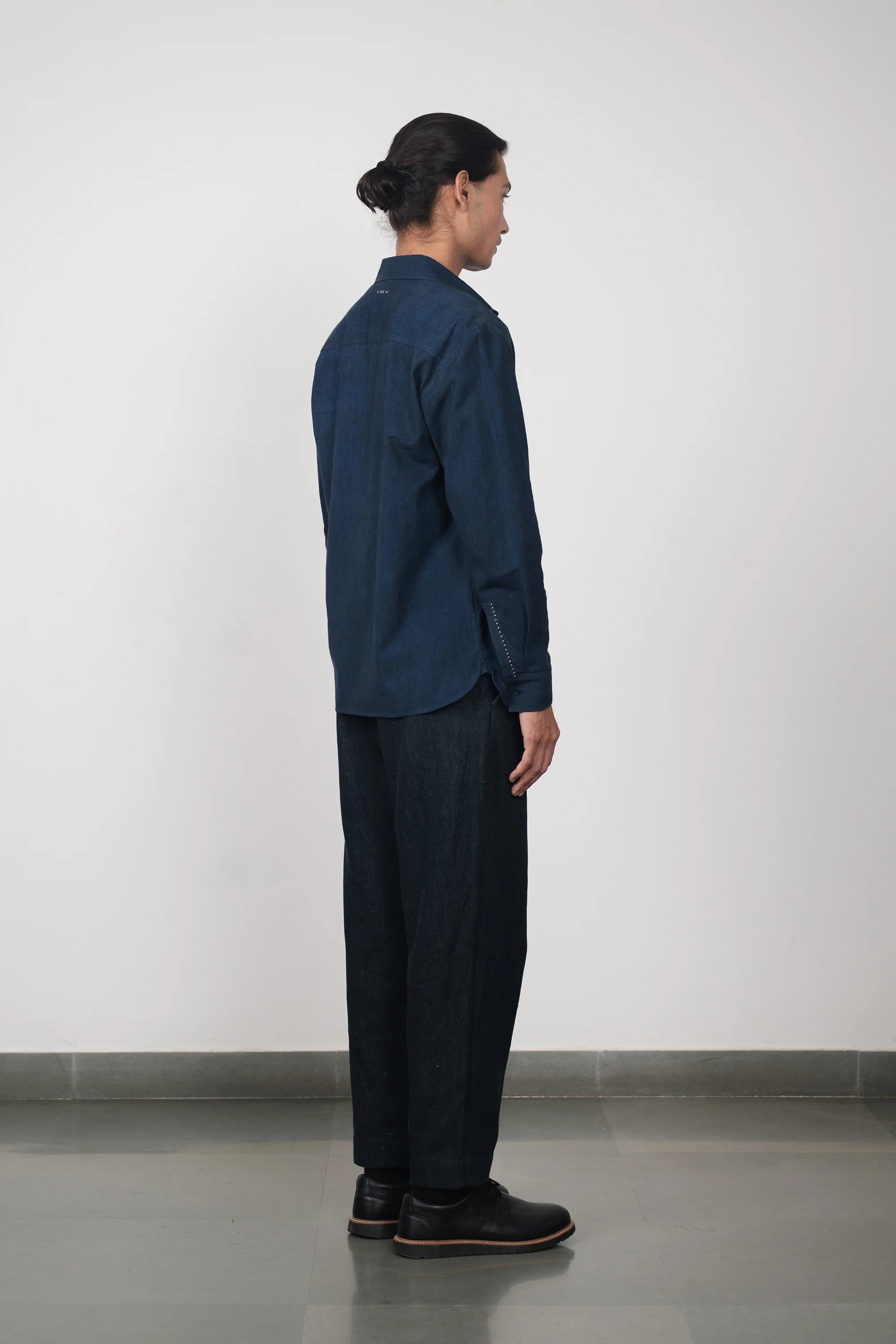 A side shot of a man wearing cotton shirt in estate blue