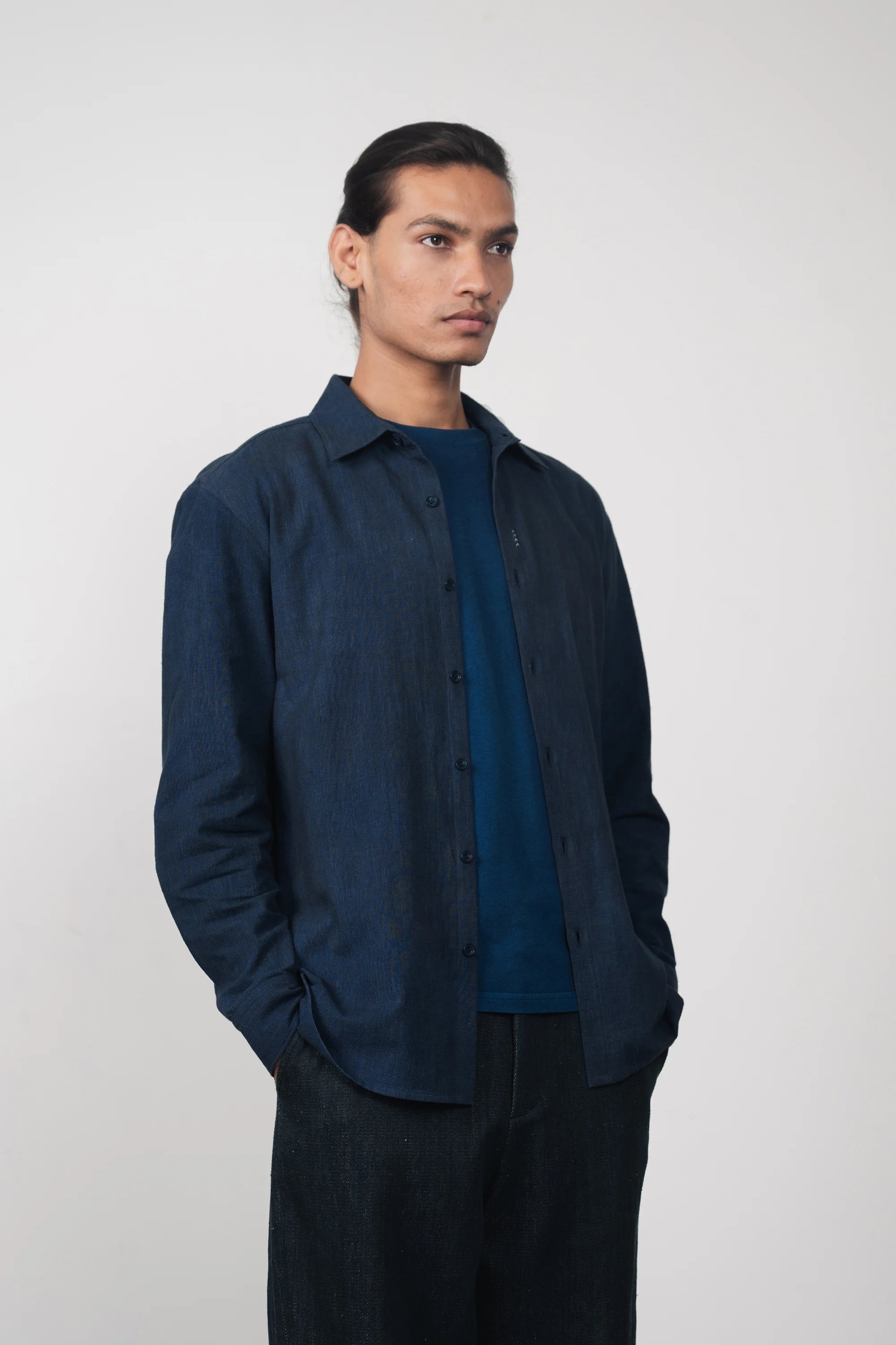 A man wearing estate blue cotton shirt with blue t-shirt