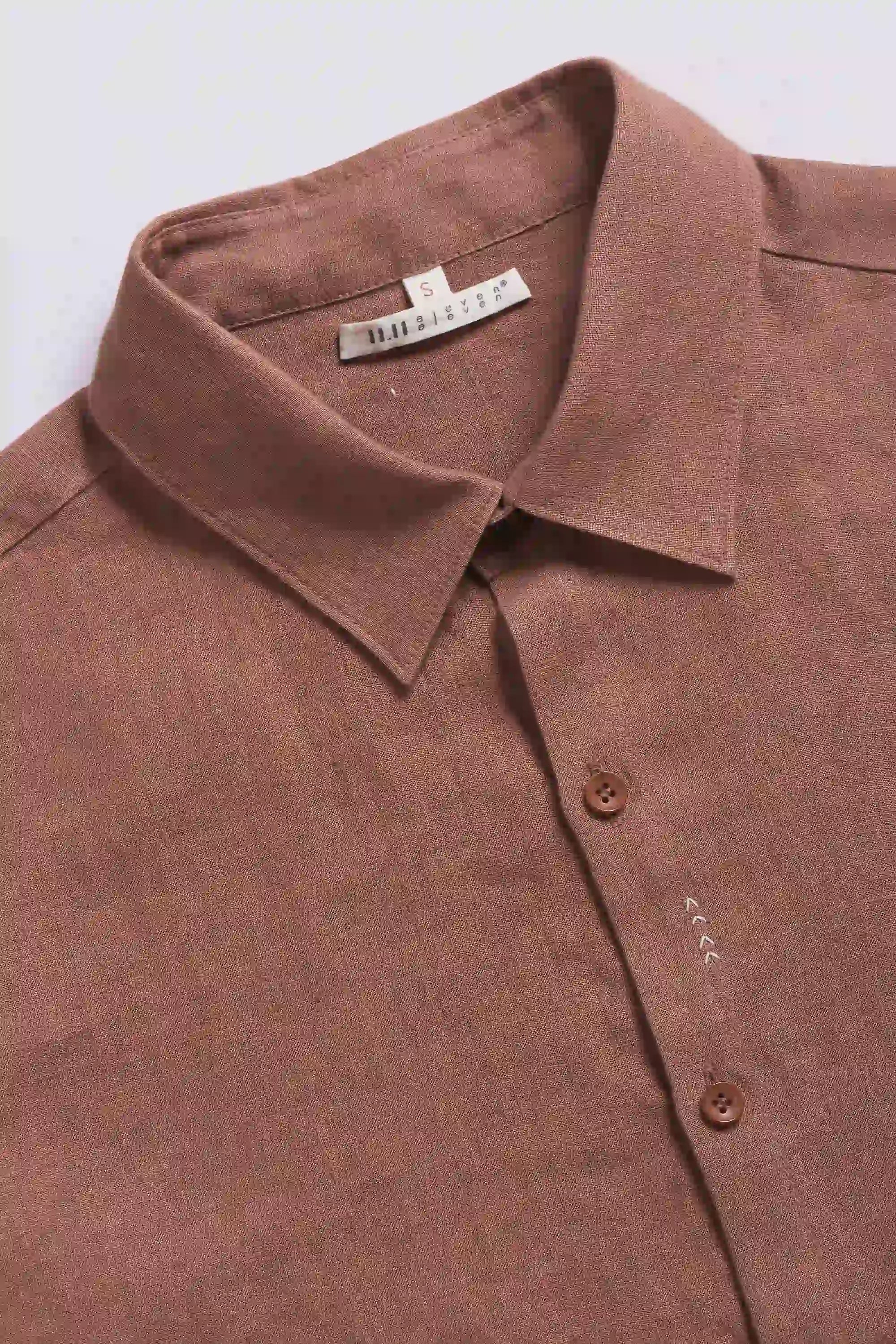 Close-up of orange rust shirt with buttons and collar