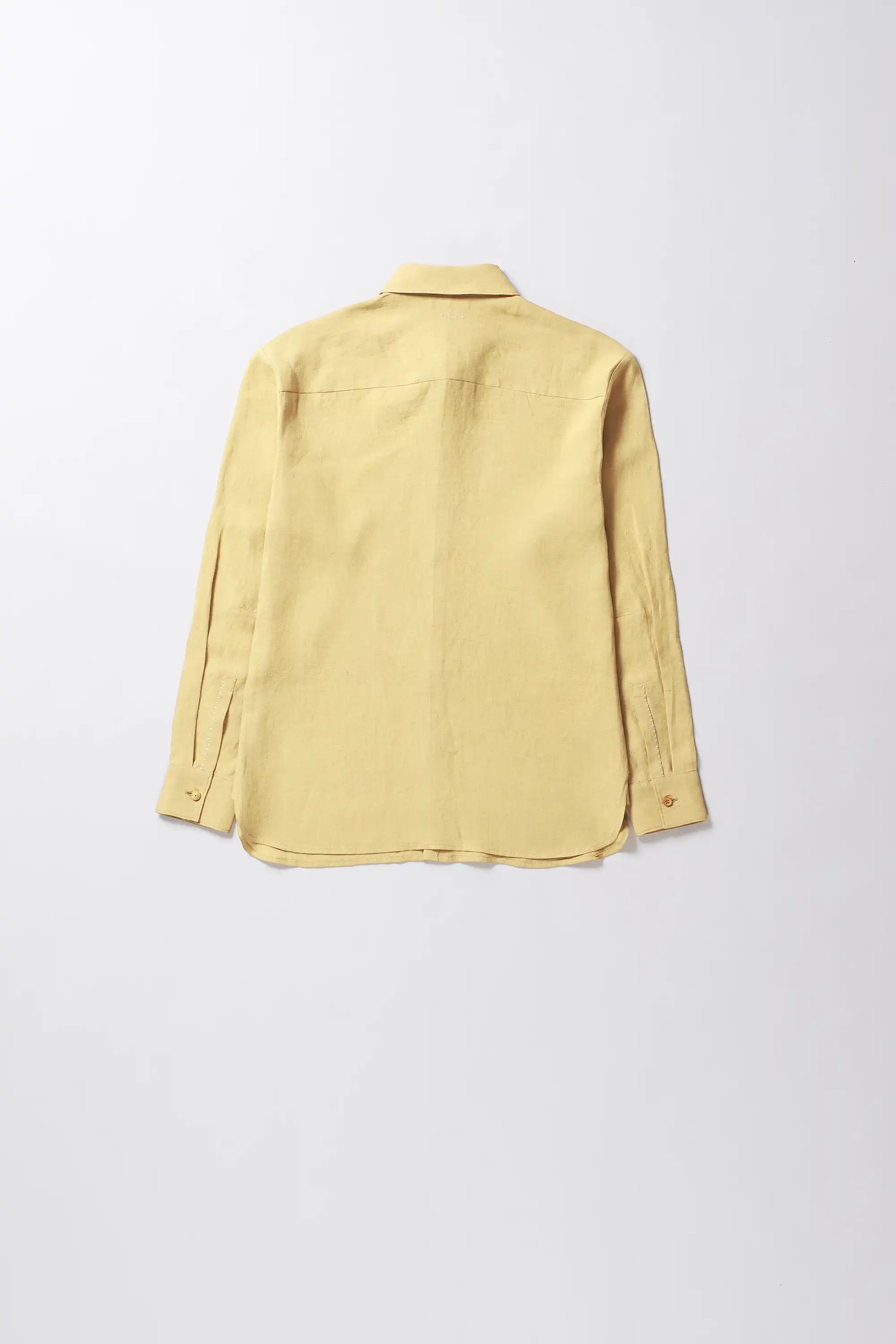 Yellow linen shirt on a light grey background