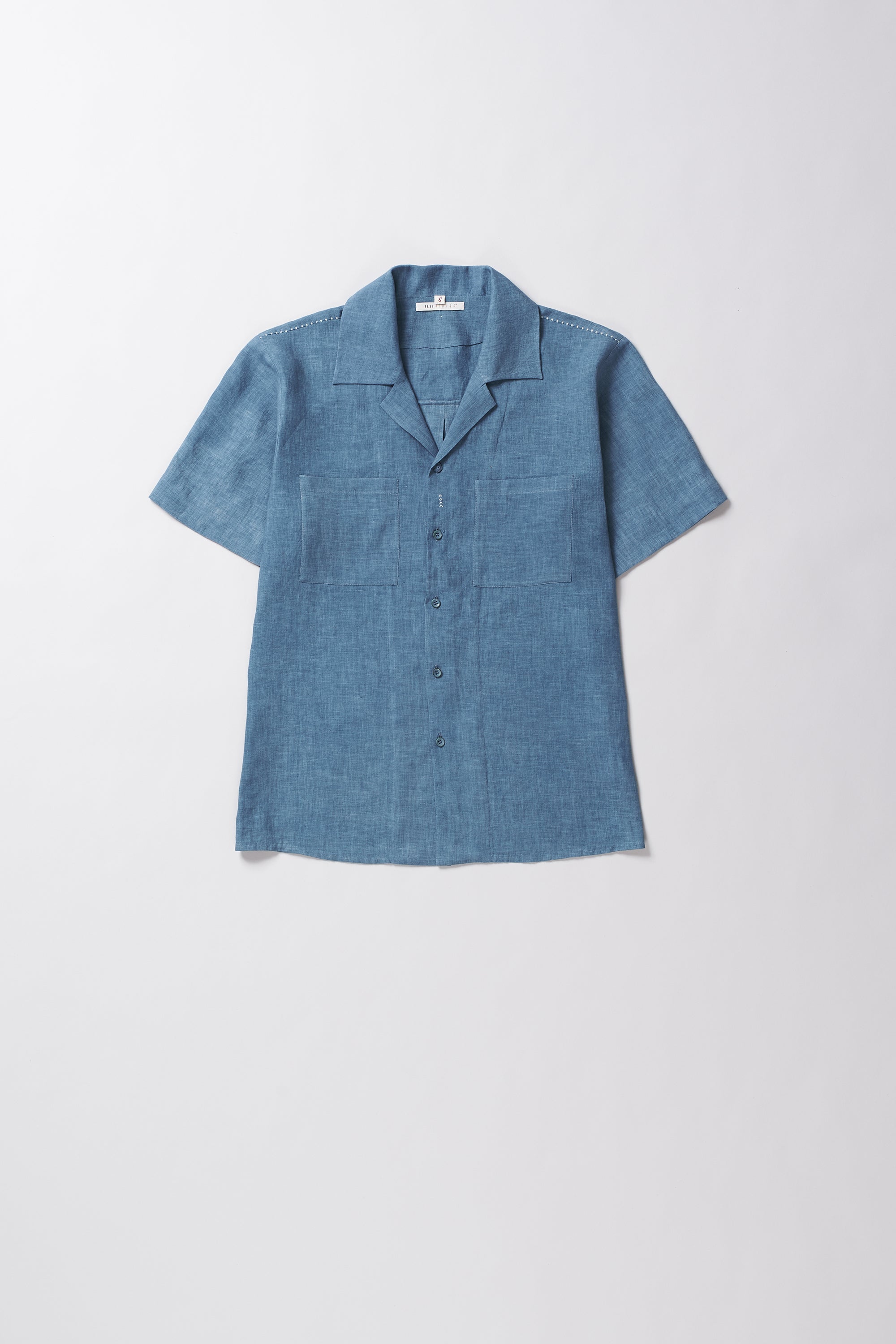 Blue short-sleeve shirt on a light grey background