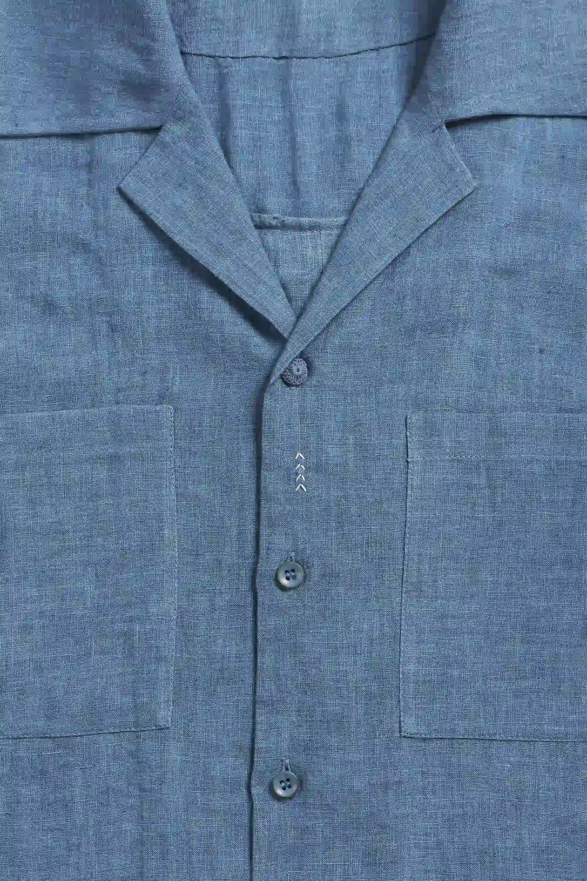 Close-up of a blue shirt with buttons and collar details