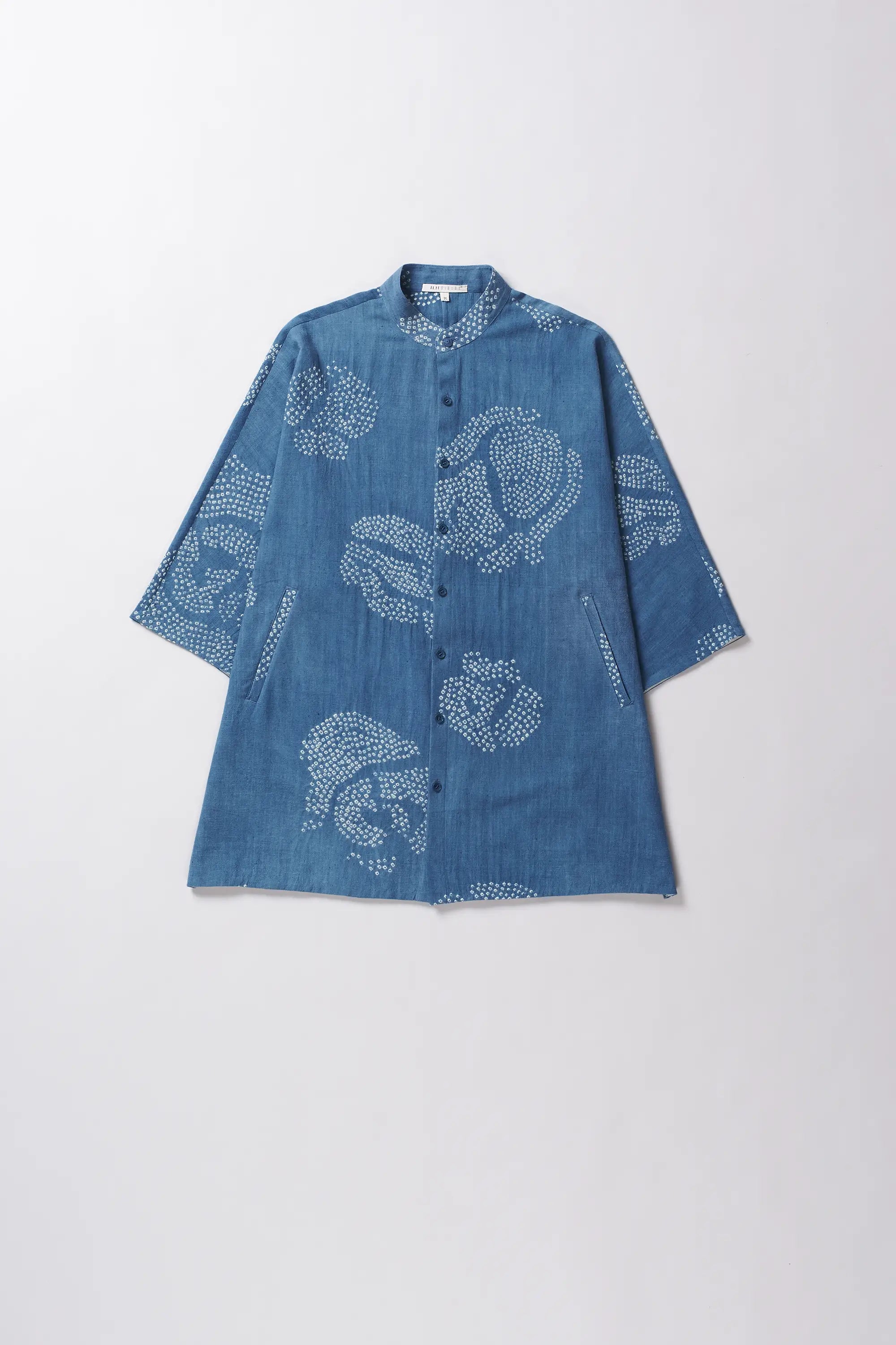 Blue cotton shirt with white floral bandhani on a light grey background