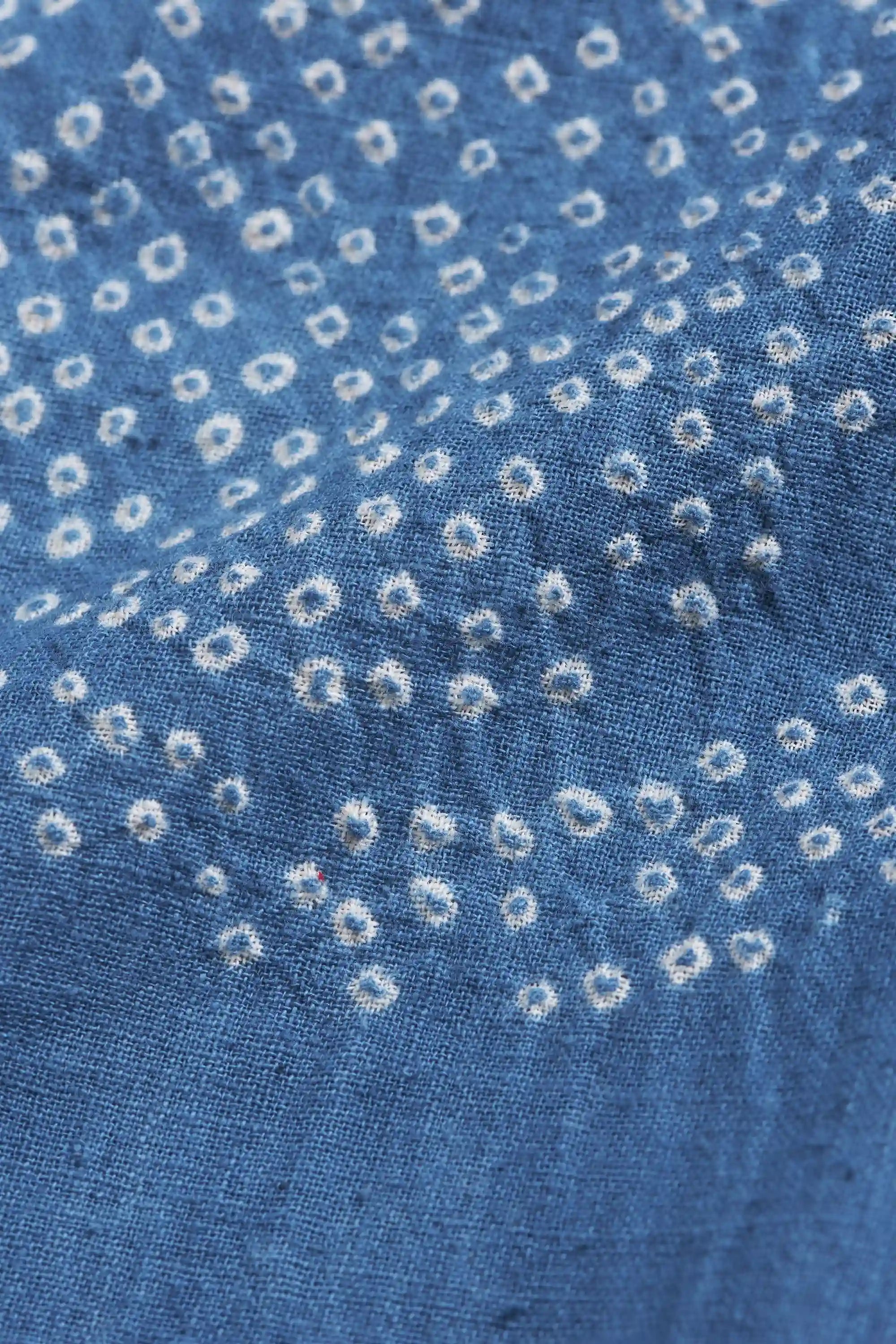 Close-up of blue fabric with bandhani