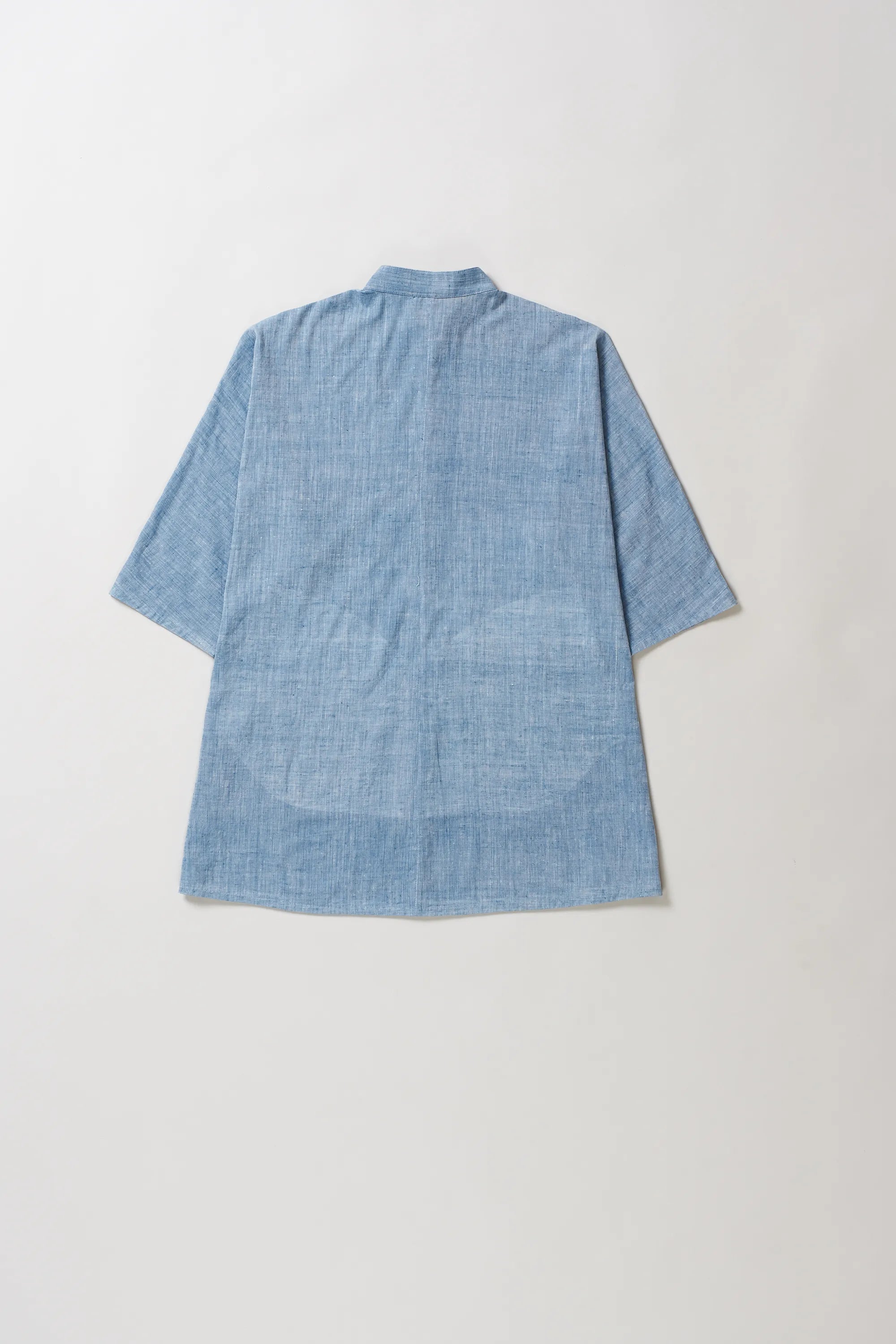 Blue shirt on a light grey background