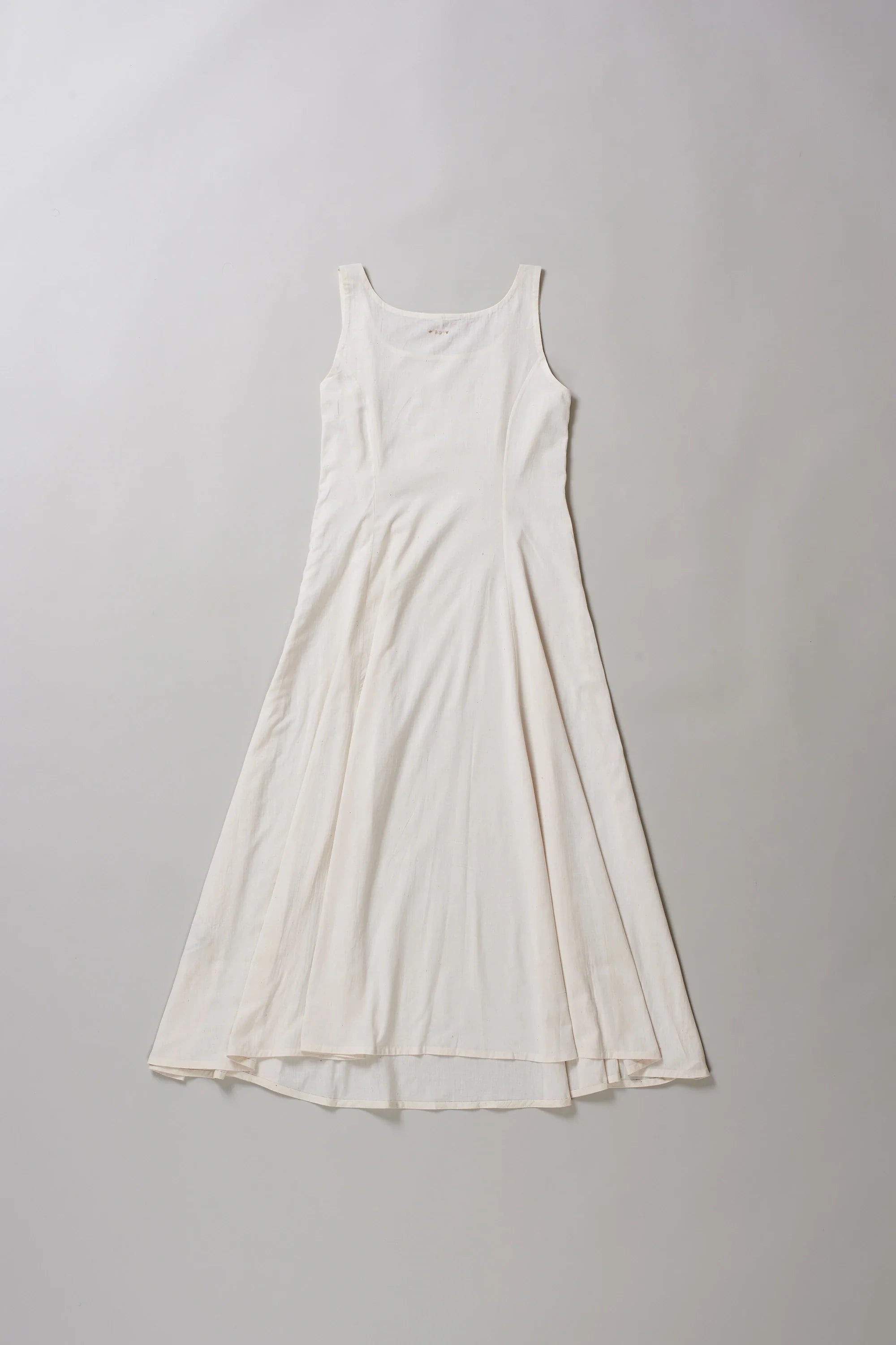 Back image of ecru dress on a grey background
