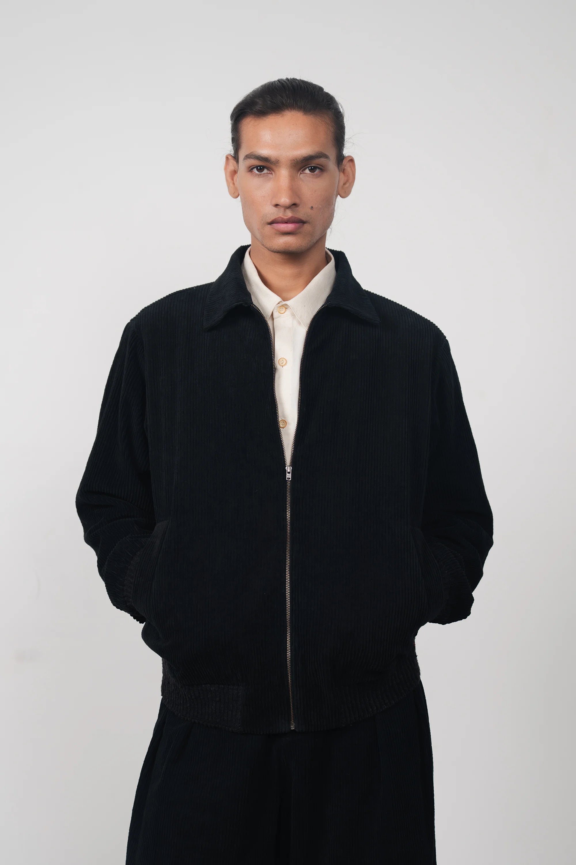 A man wearing black cotton jacket in black