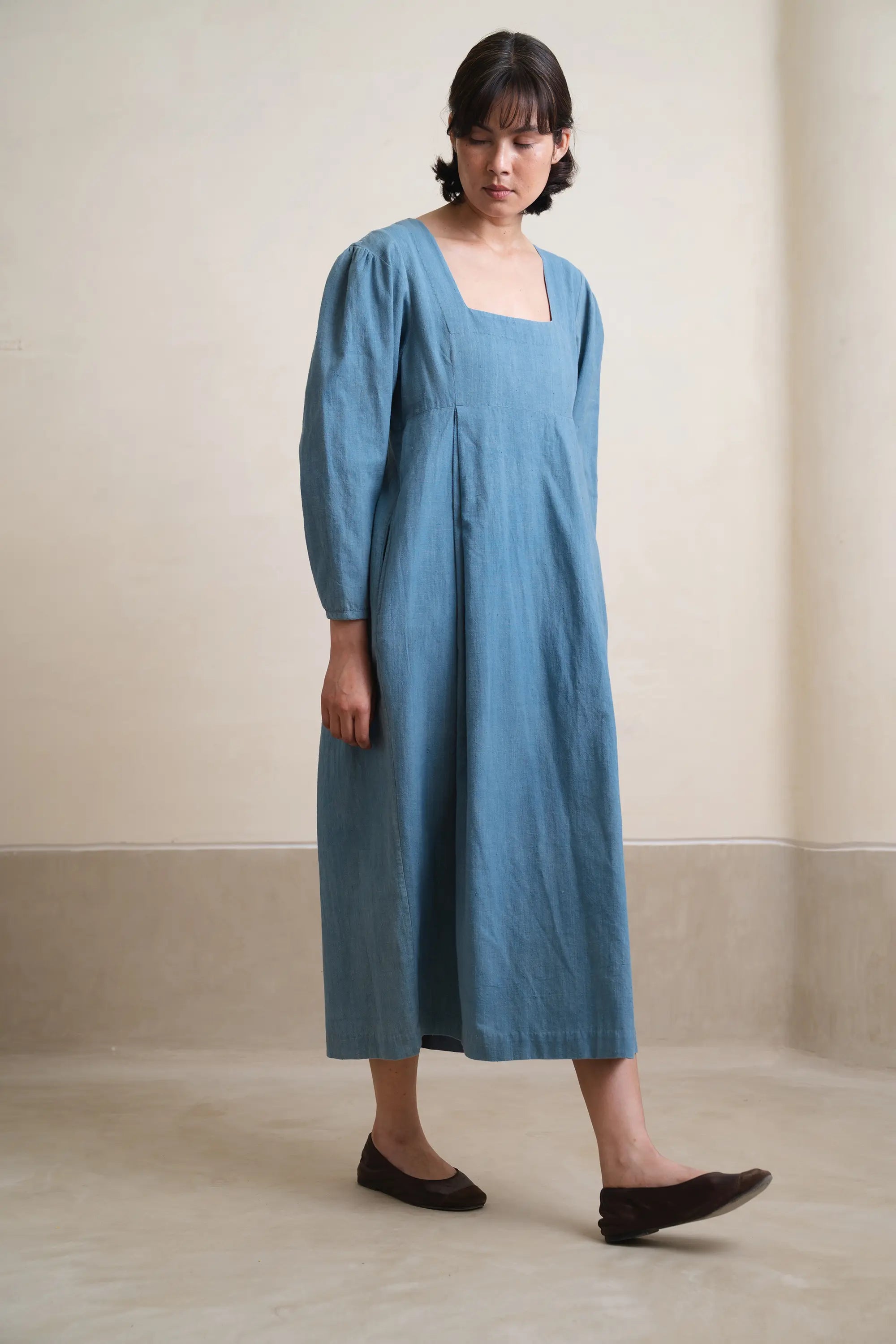 A woman wearing powder blue dress