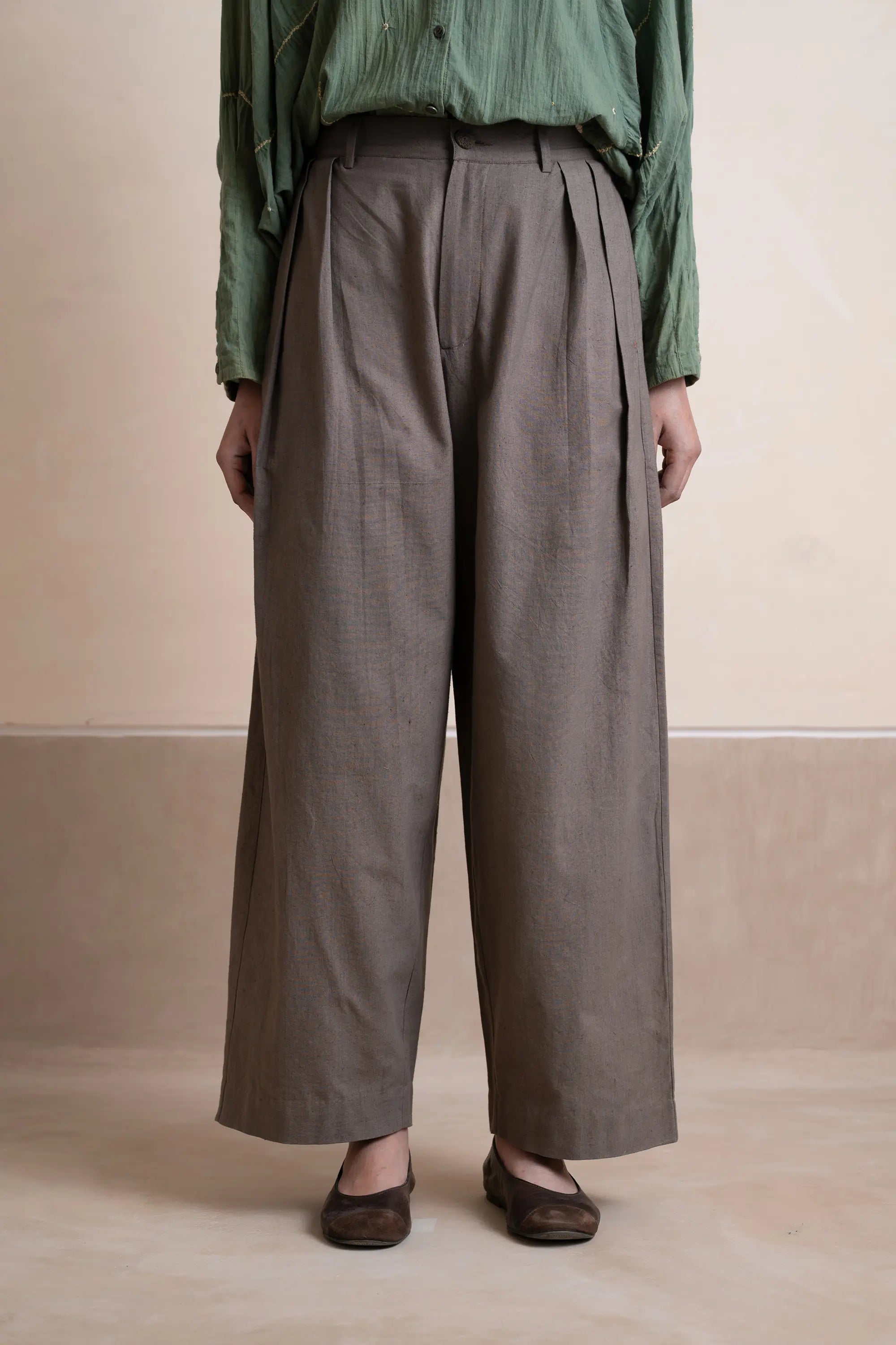 A woman wearing ash grey cotton pant