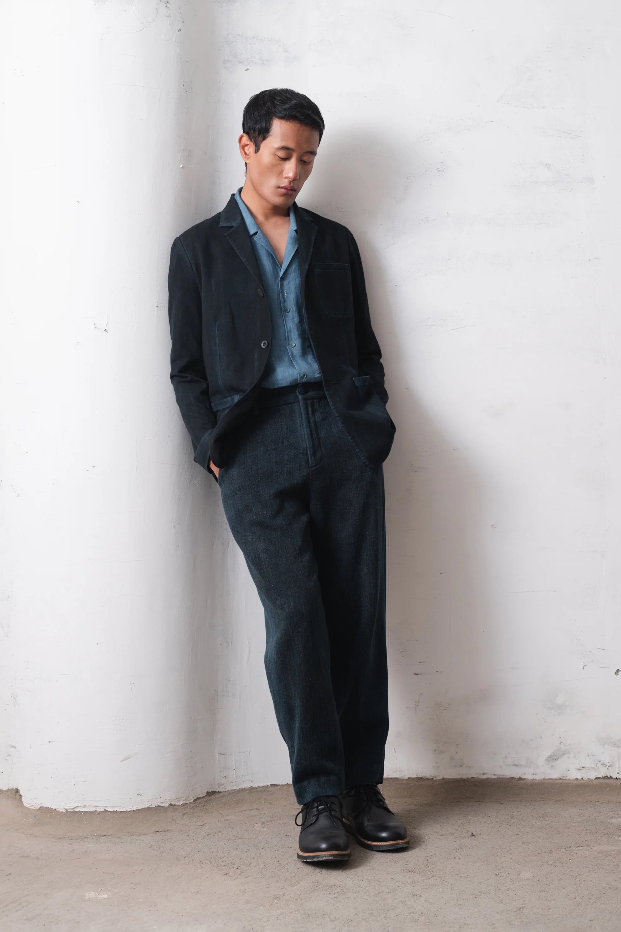 Man wearing a black jacket with light blue shirt