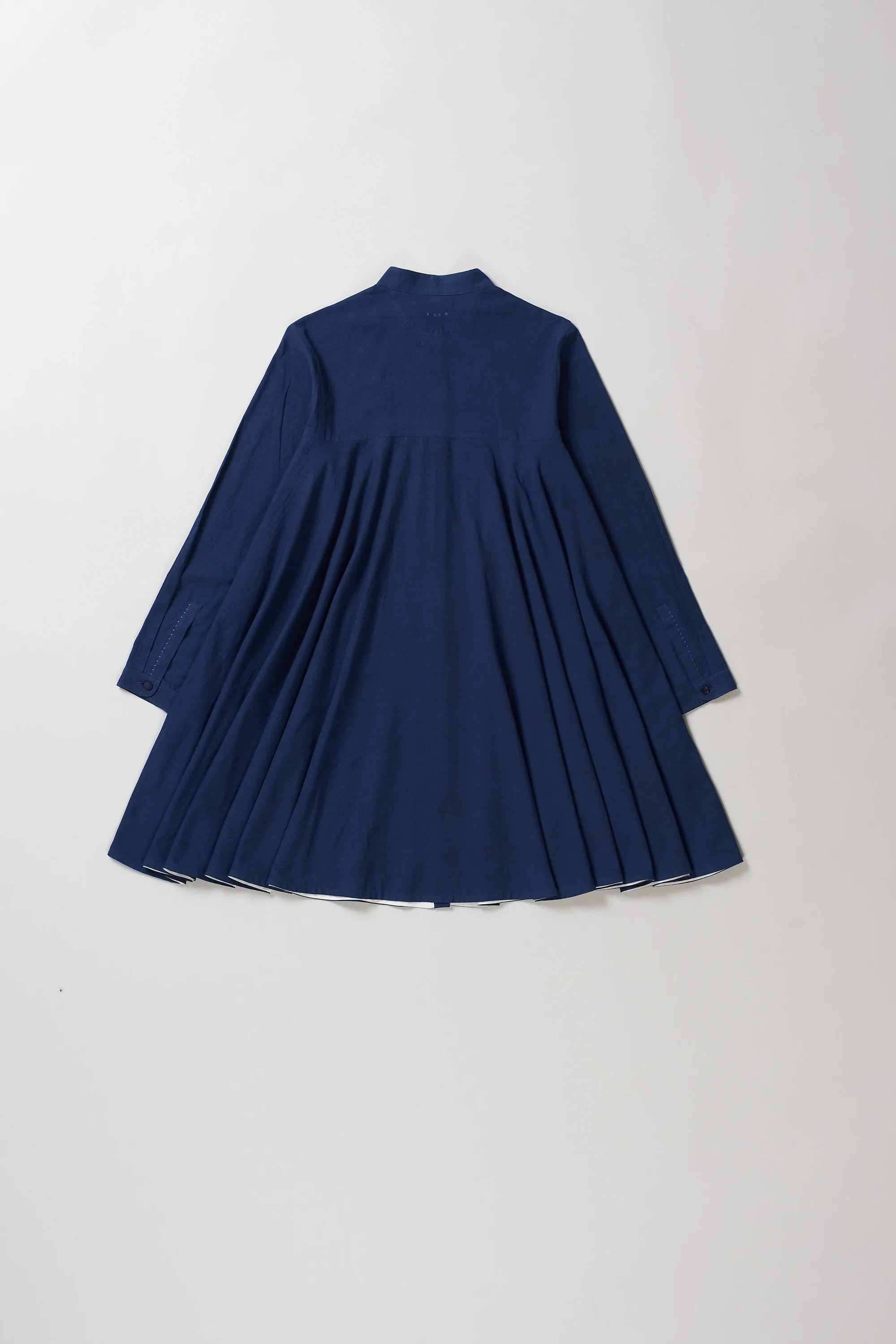 Back image of indigo dress on a light grey background