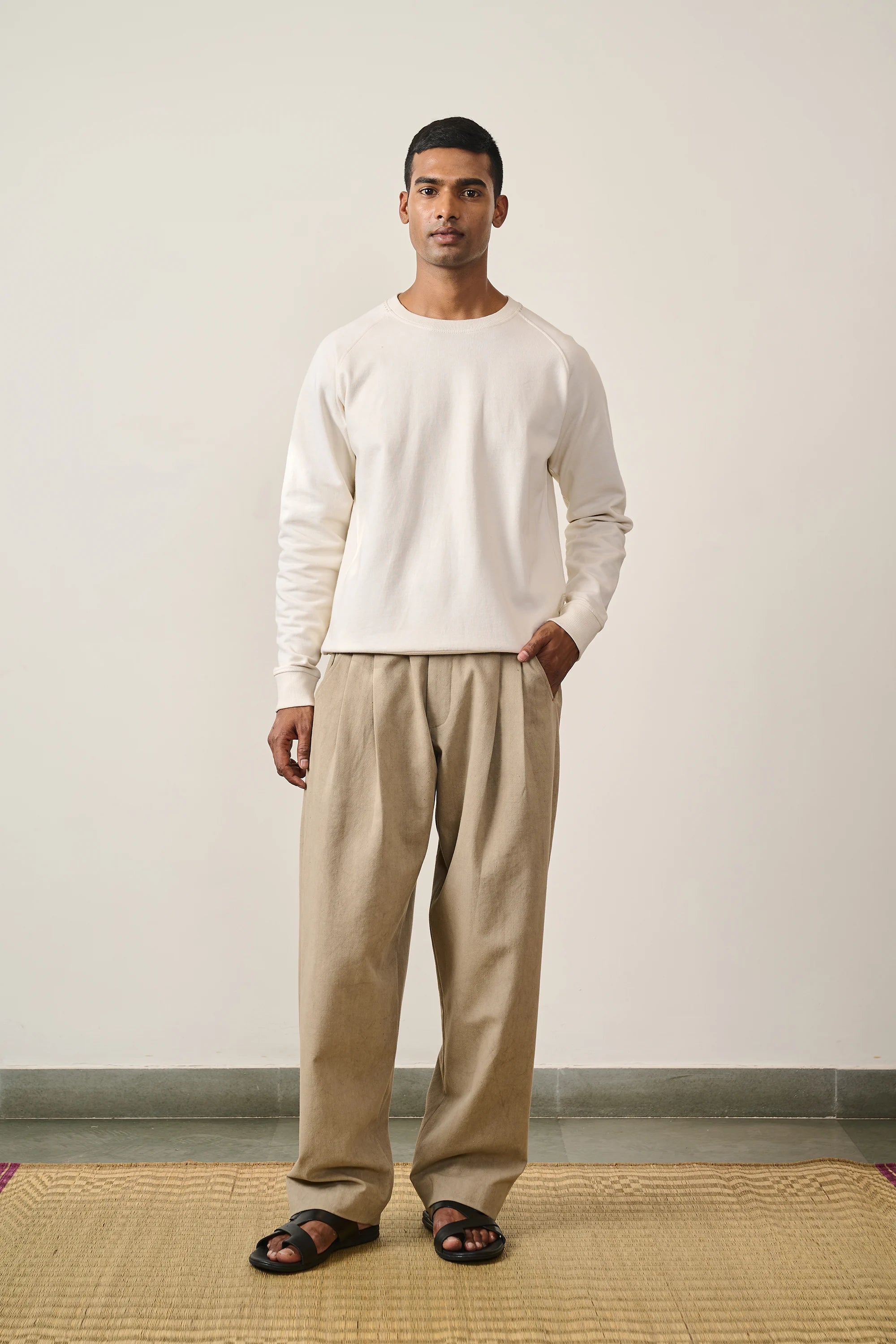A man wearing ecru sweatshirt with hand detailing