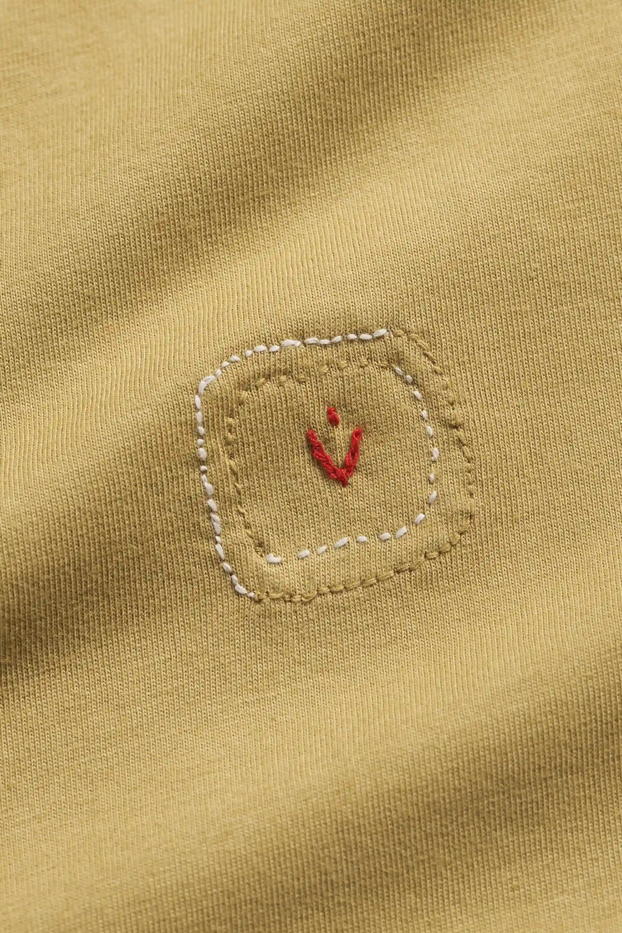 Close-up of a fabric with a small red pehchanbox