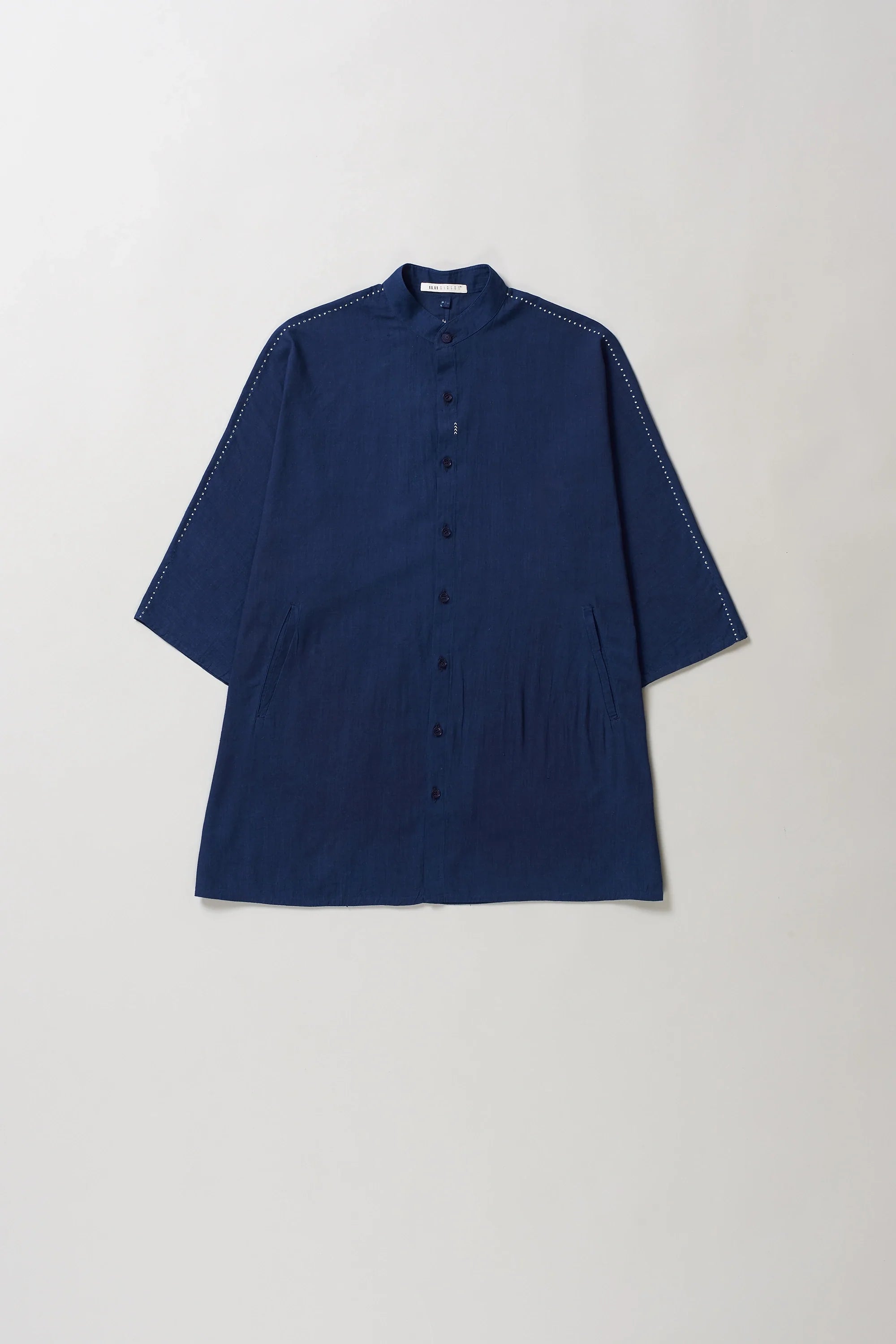 Blue cotton shirt on a light grey background