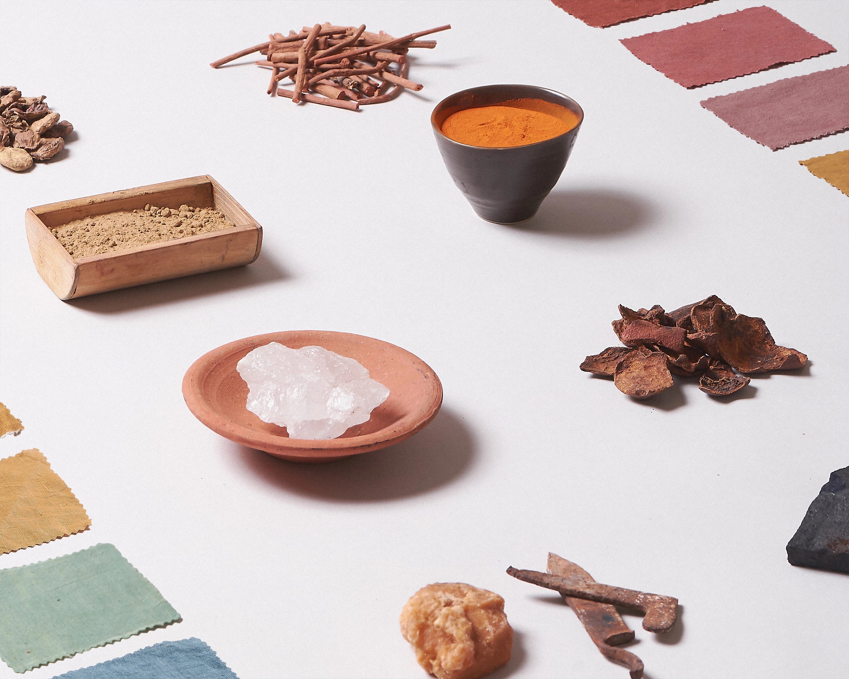 Spices and herbs on a white surface with a focus on color and texture.