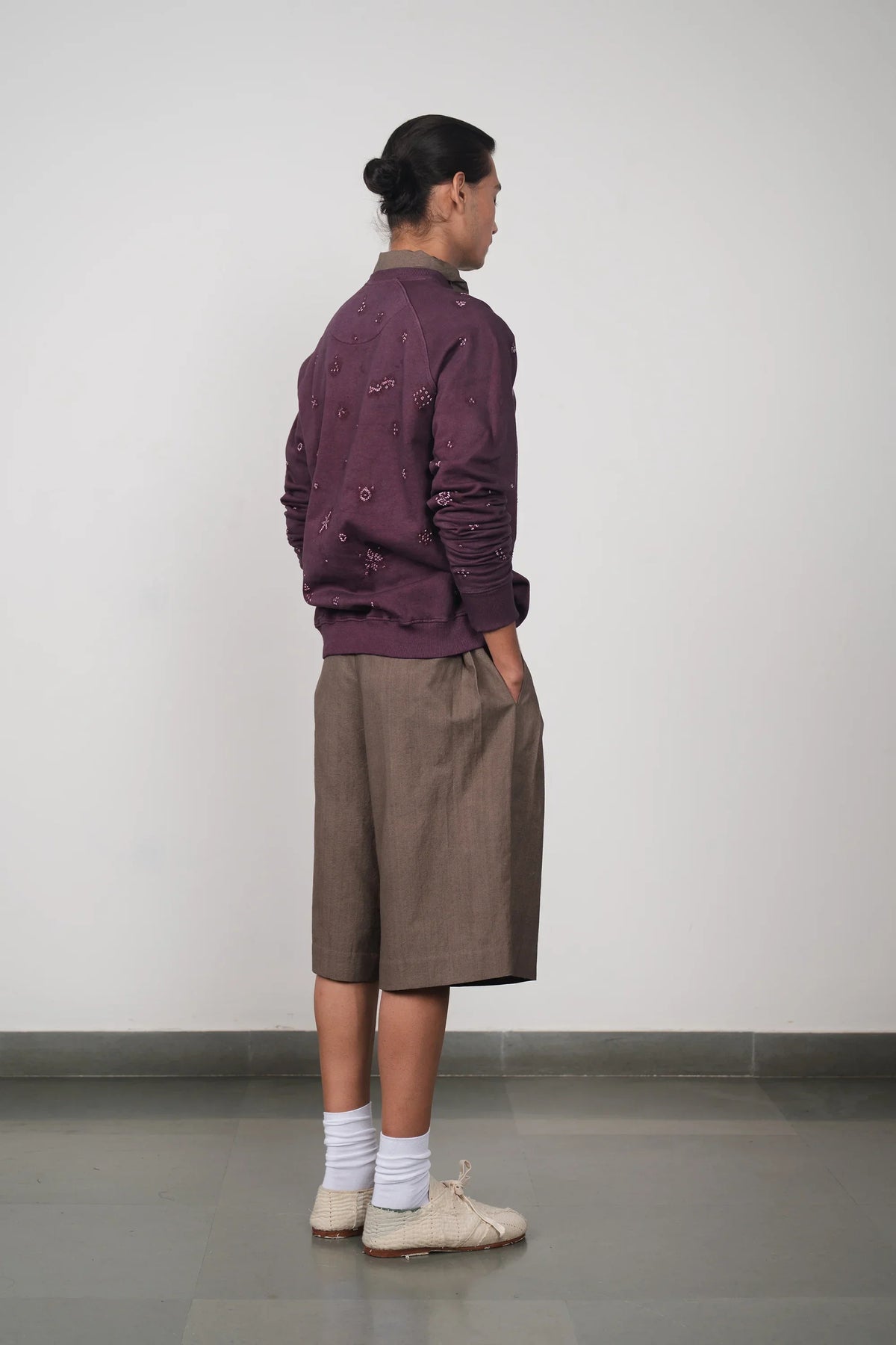 A man wearing purple red sweatshirt