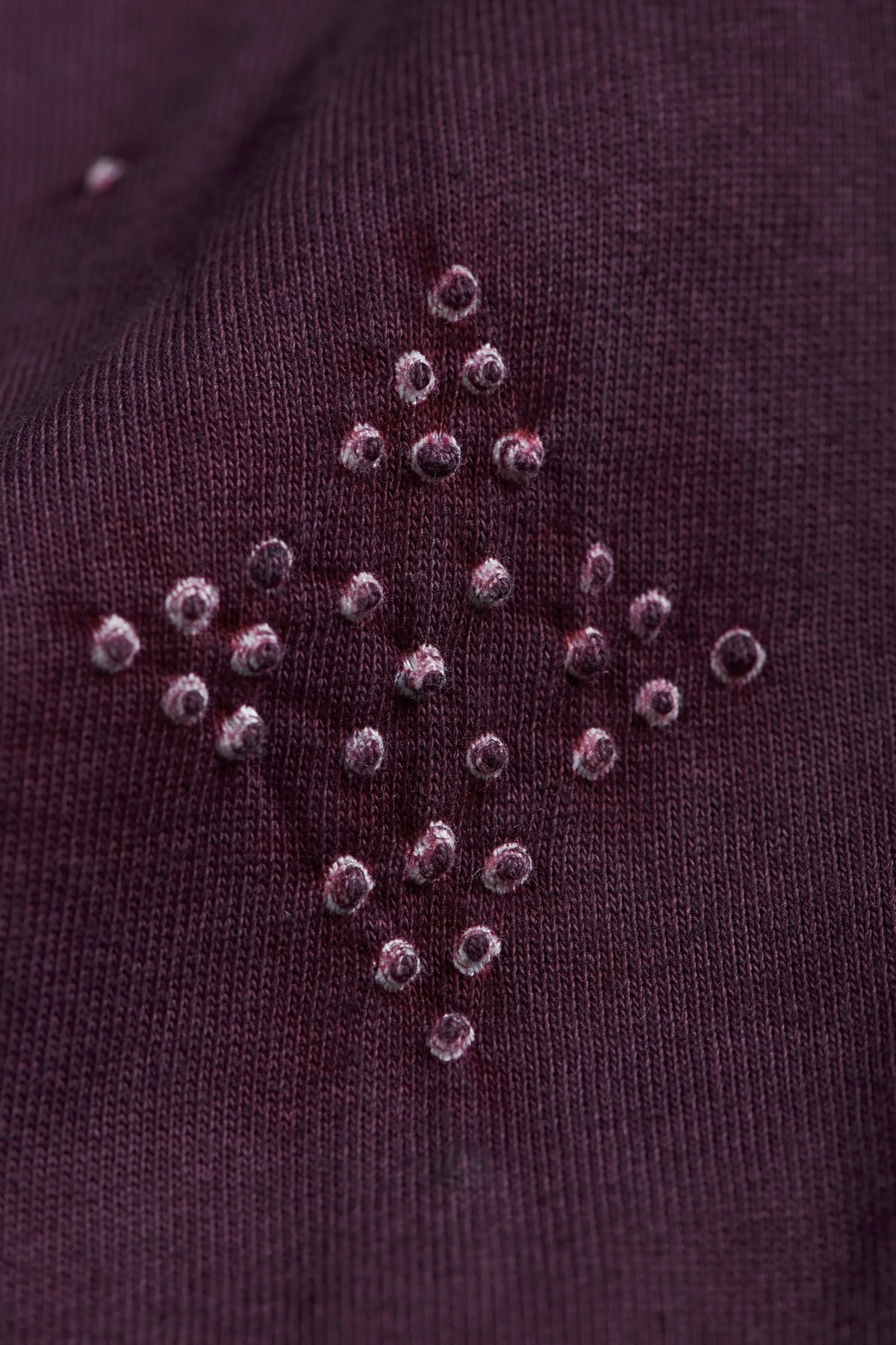 A man wearing purple red sweatshirt
