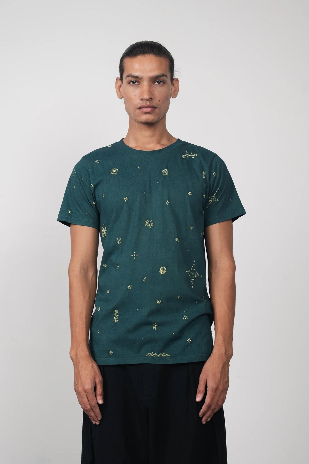 A man wearing bottel green t-shirt