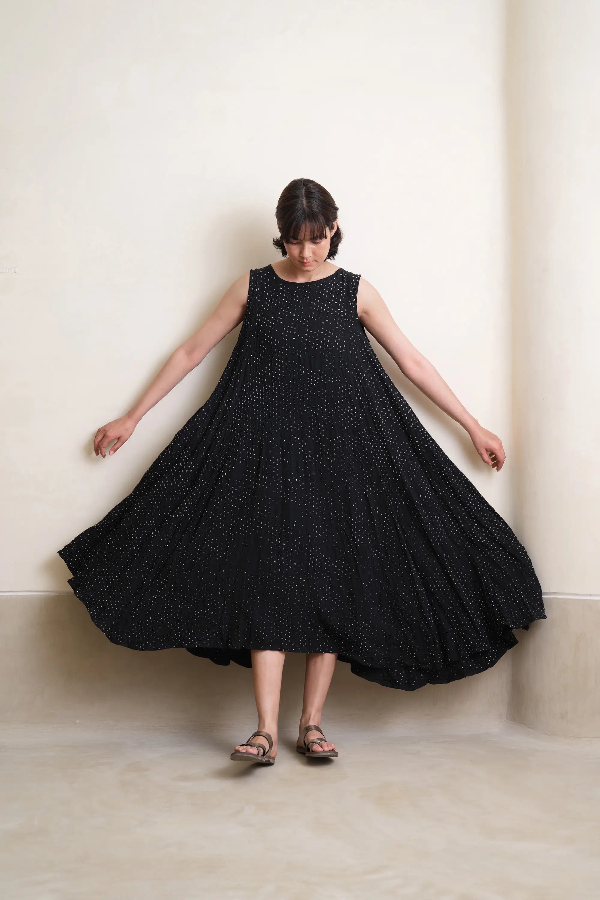 A woman wearing black bandhani silk dress