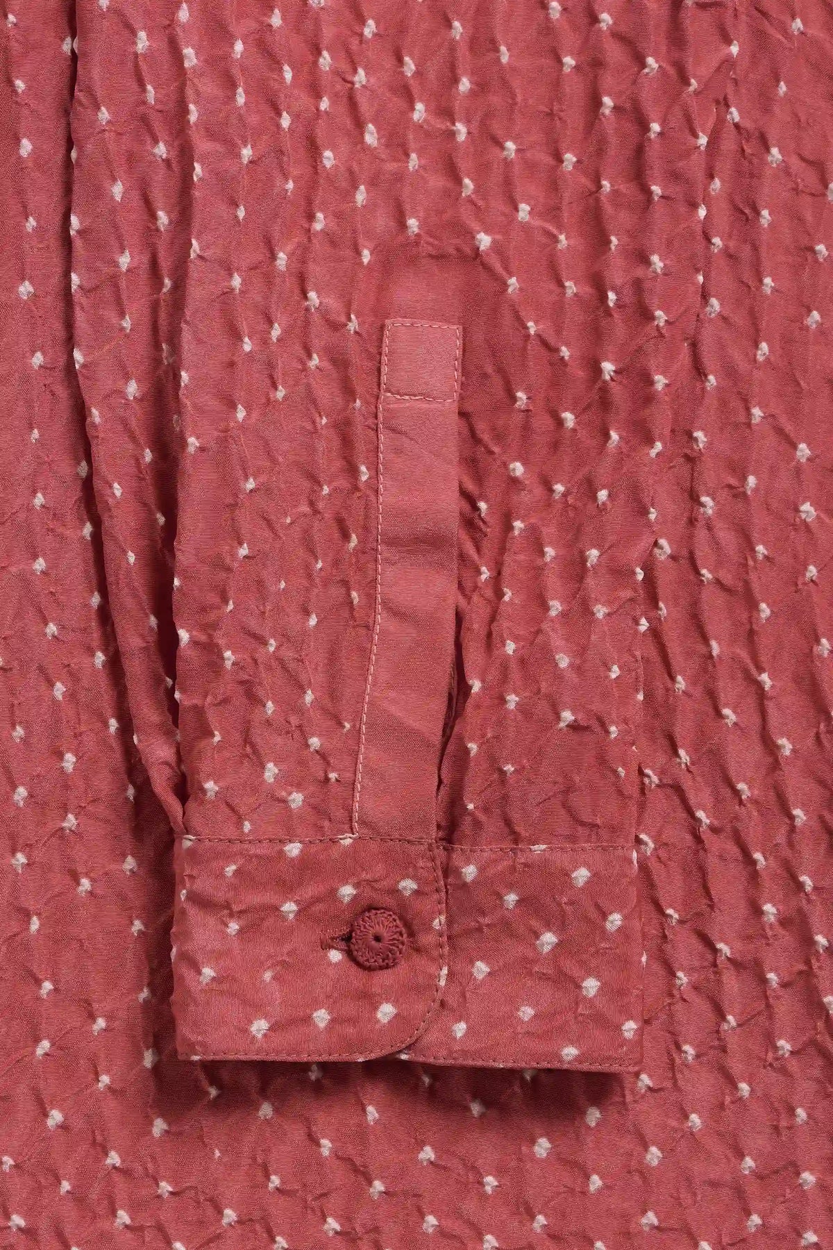 Close-up of a sleeve, featuring a buttoned cuff.