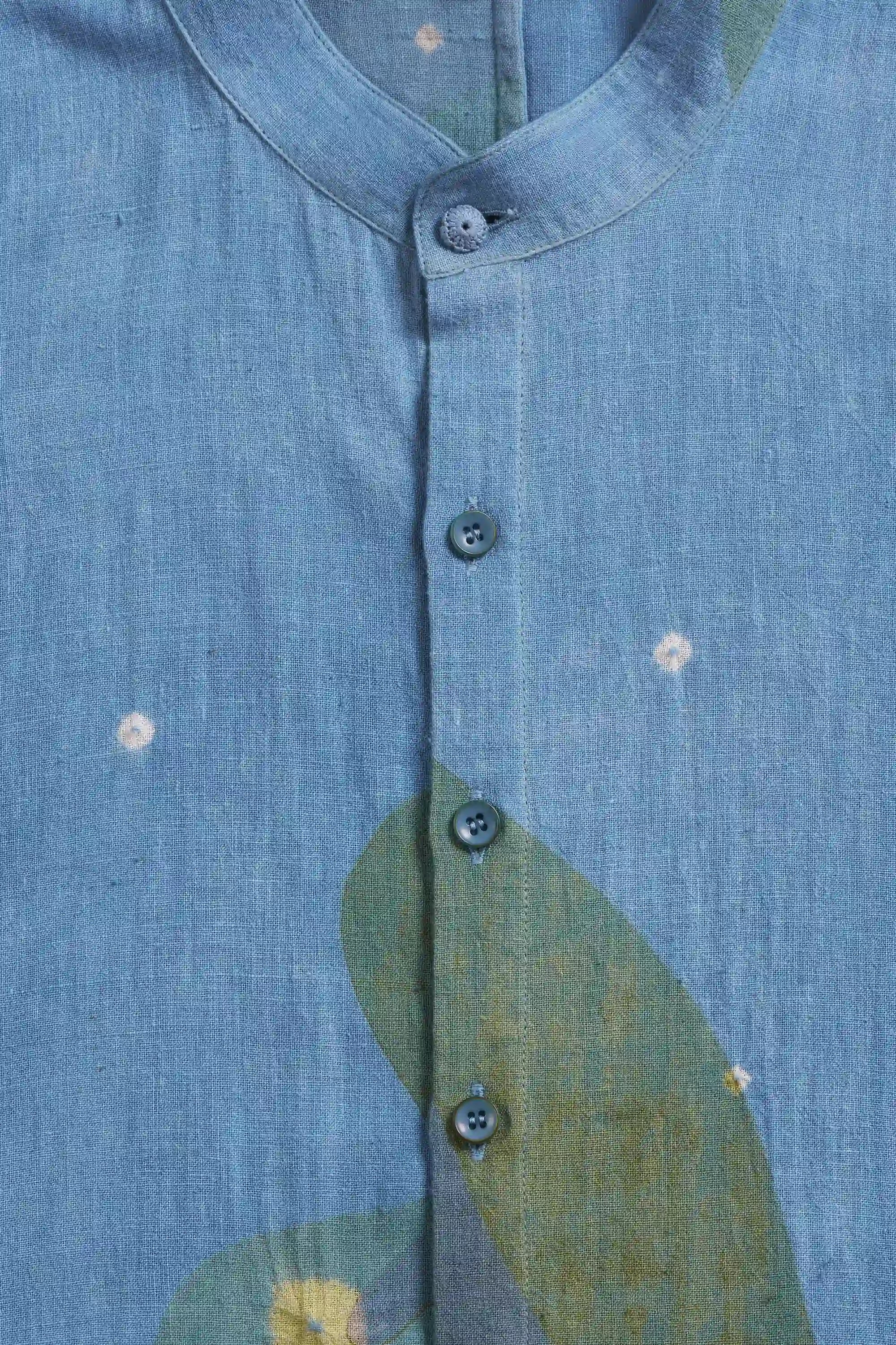 Close-up of a blue cotton shirt with floral patterns and buttons