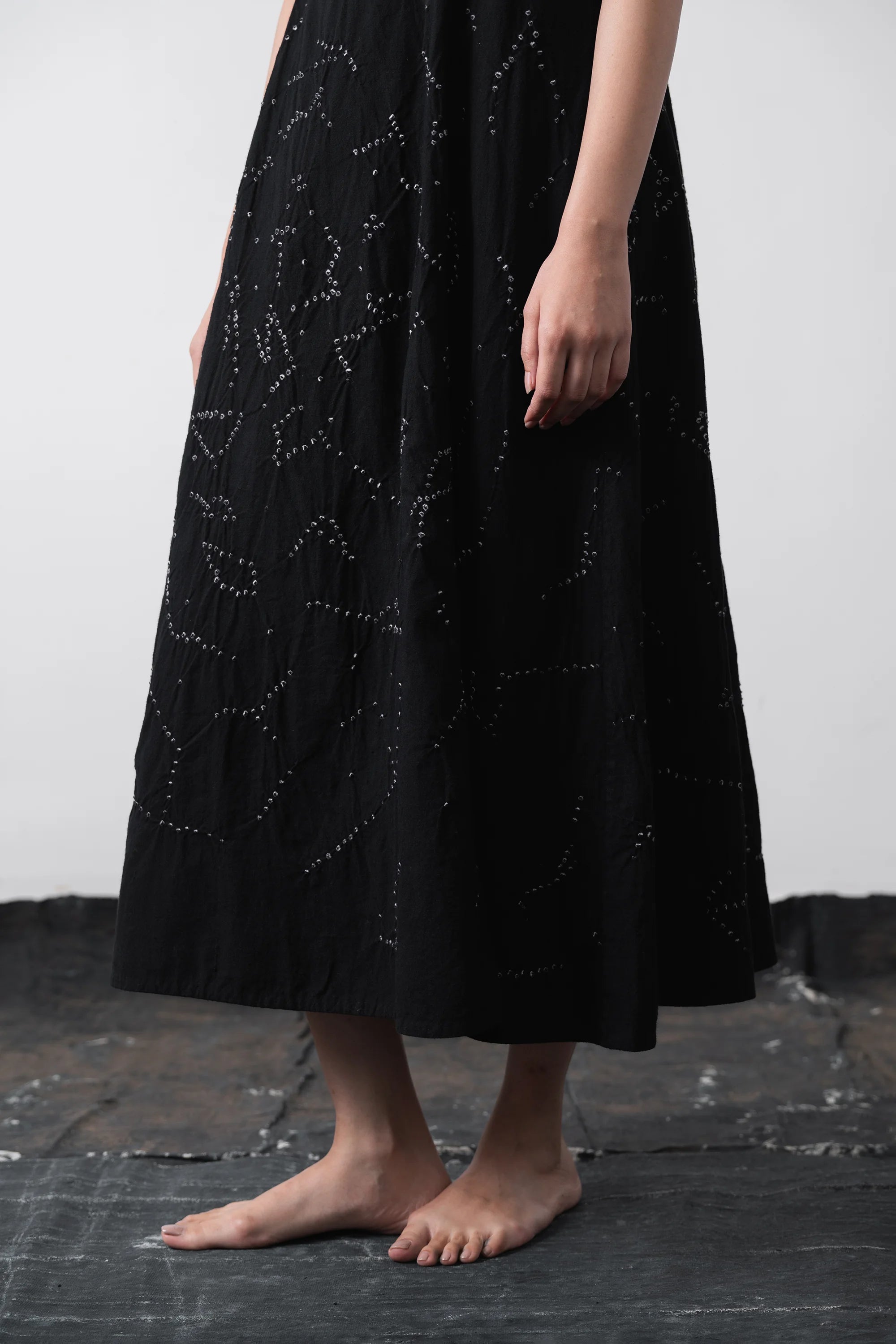 A person wearing a long black midi dress Flared.