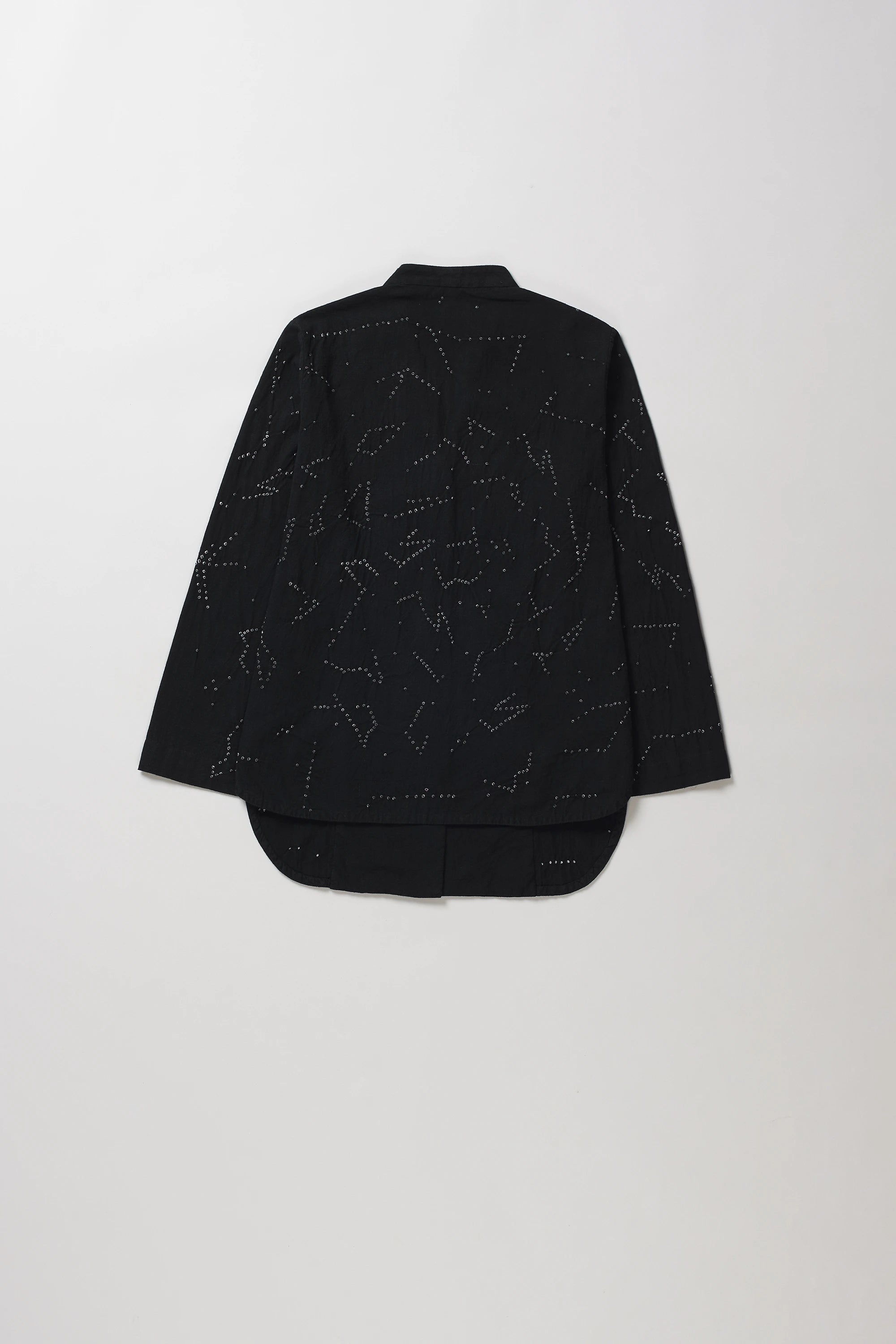A black long-sleeve cropped shirt with shibori artwork, shown from the back against a light grey background.