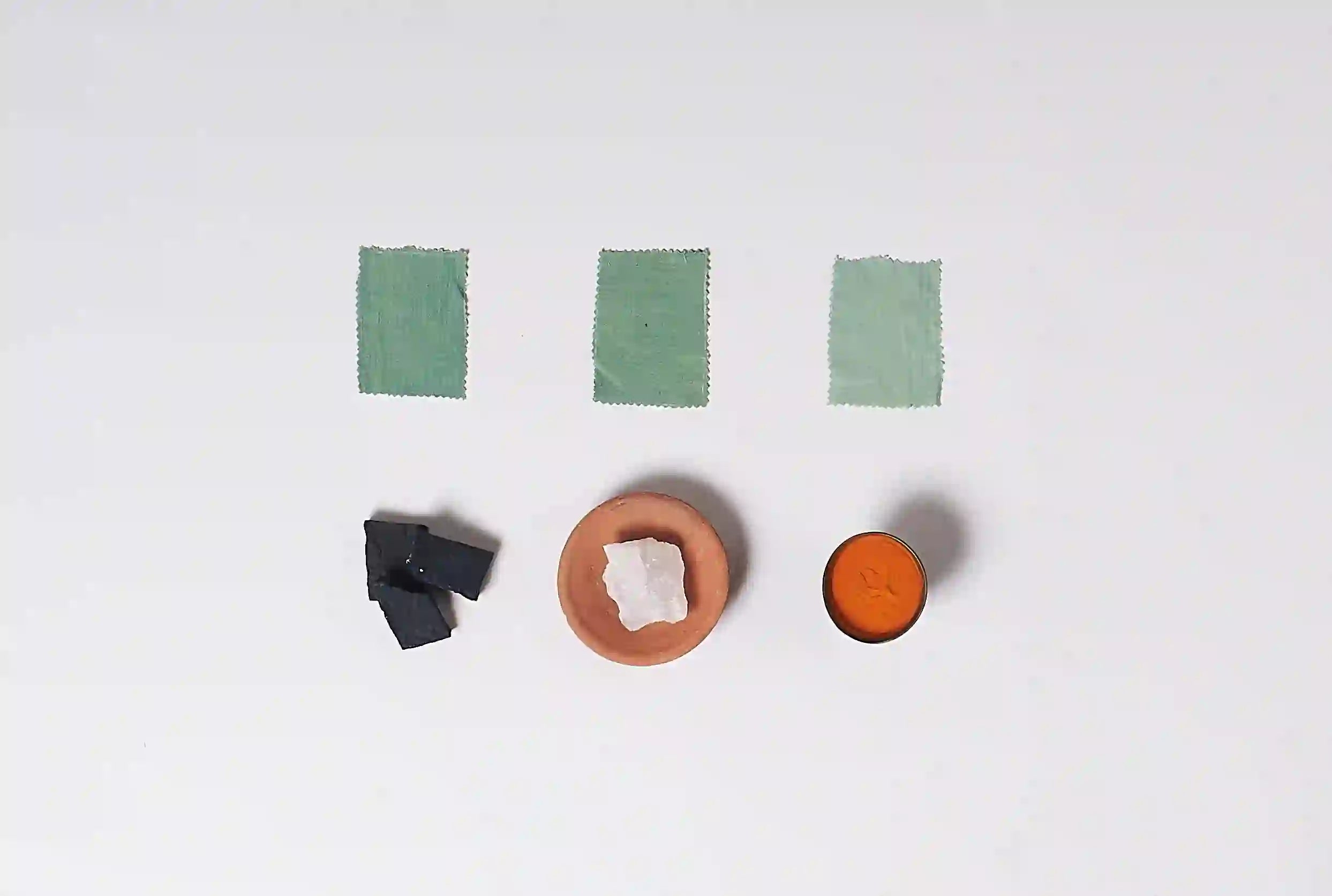 Color swatches and small containers on a white background
