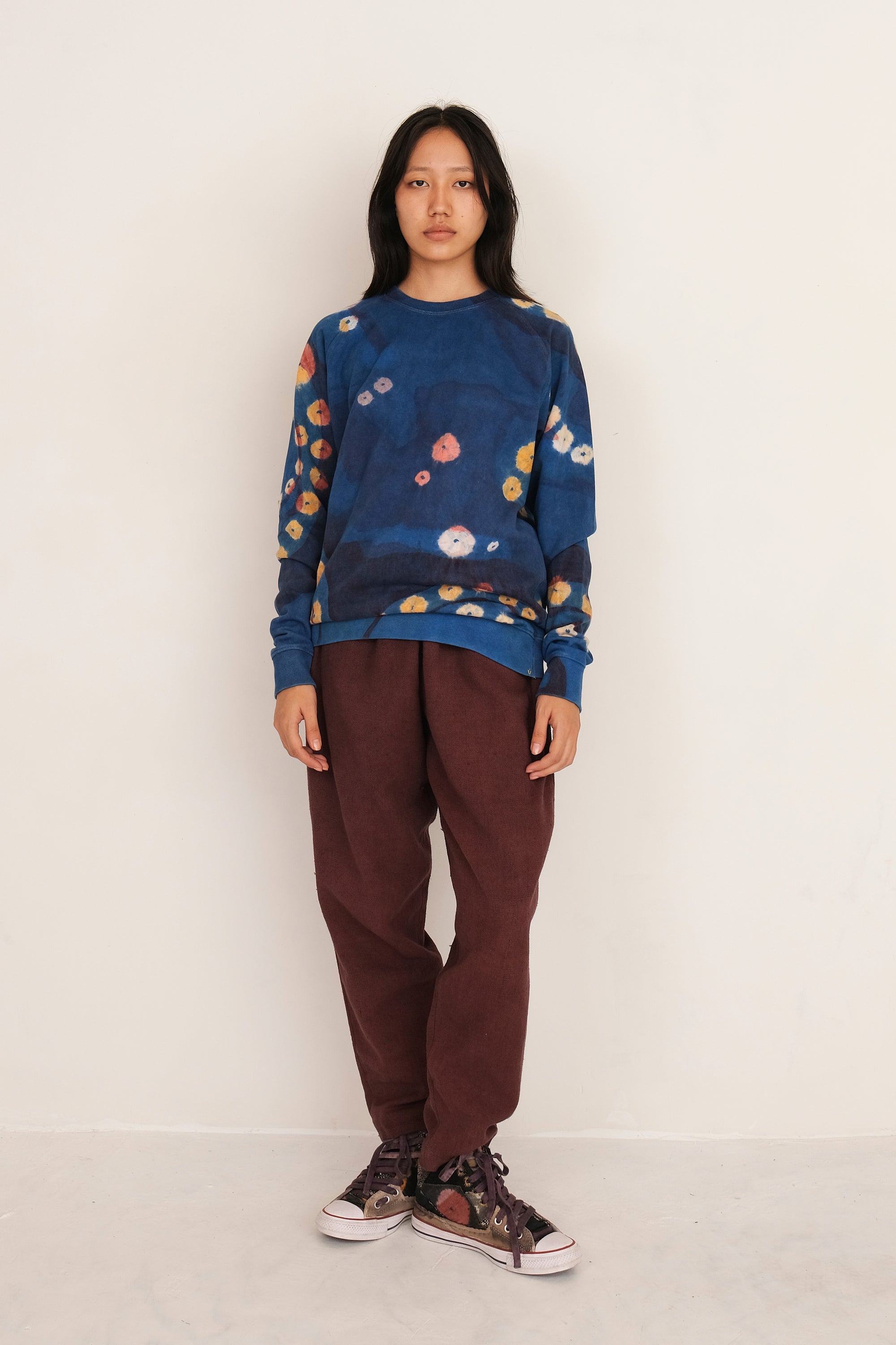 A woman wearing medium indigo cotton sweatshirt