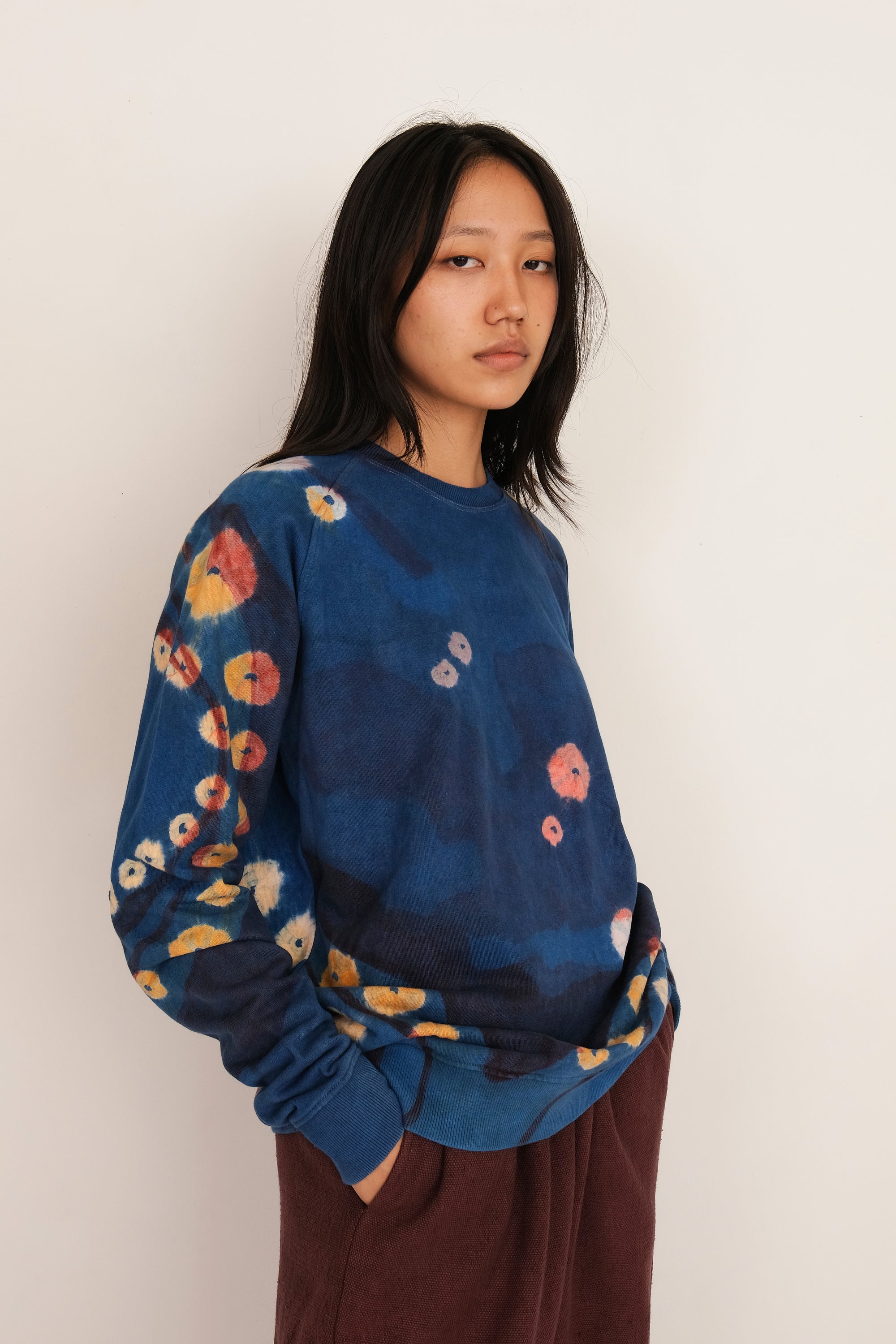 A woman wearing medium indigo sweatshirt