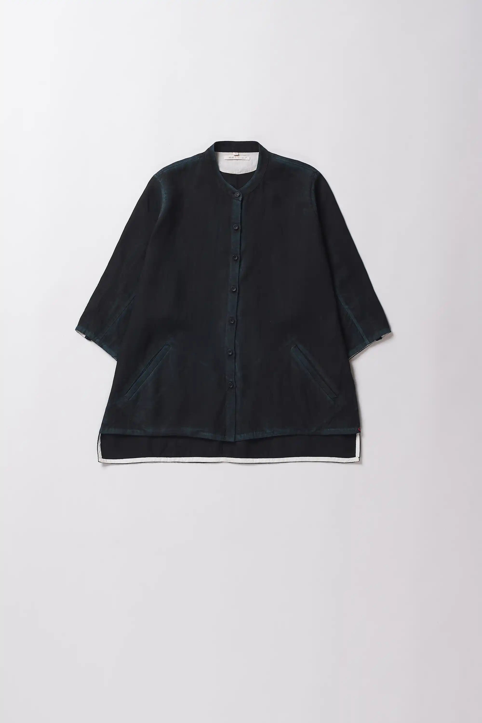 Black shirt with a band collar on a grey background