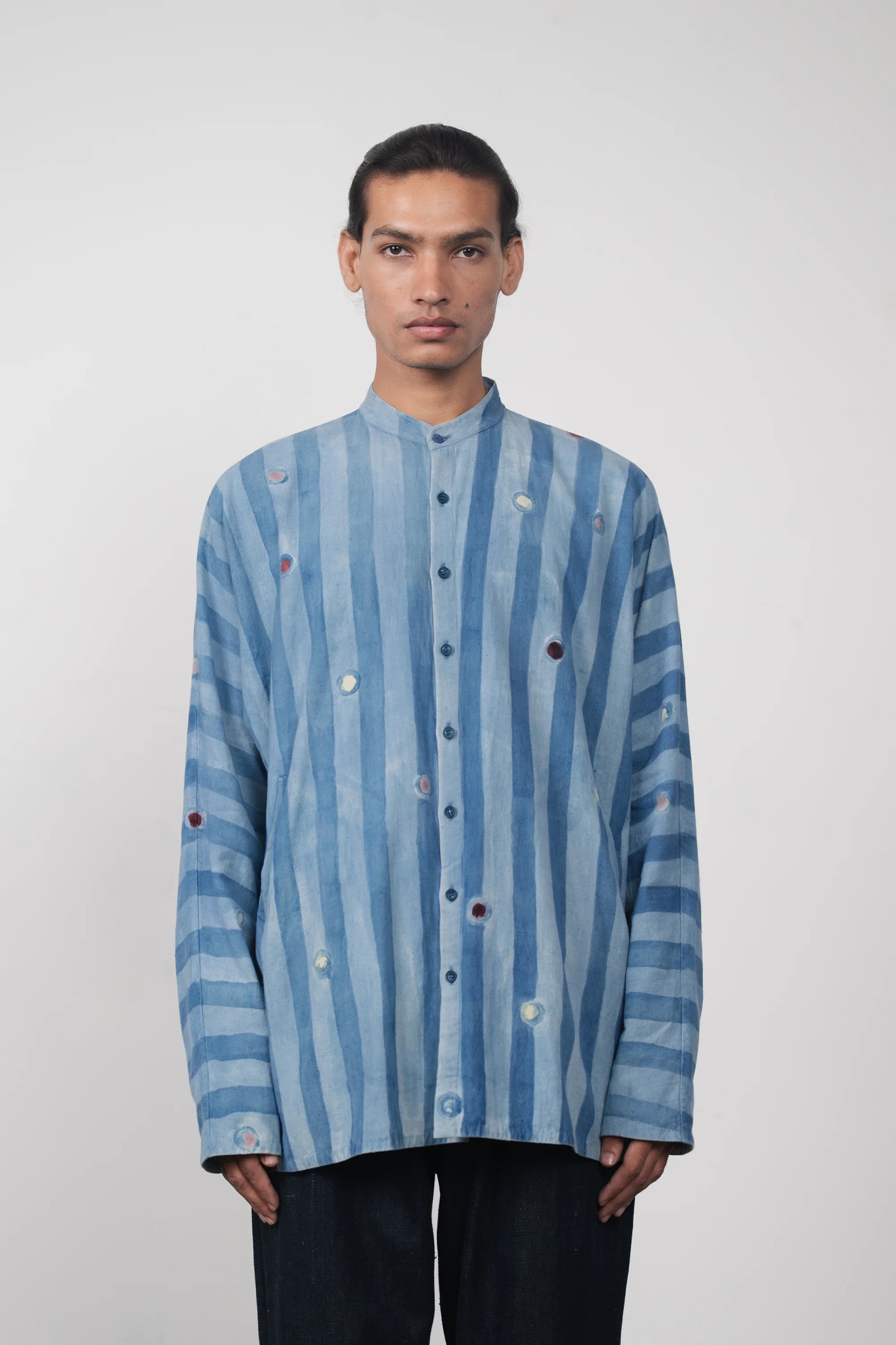 A man wearing light indigo cotton shirt