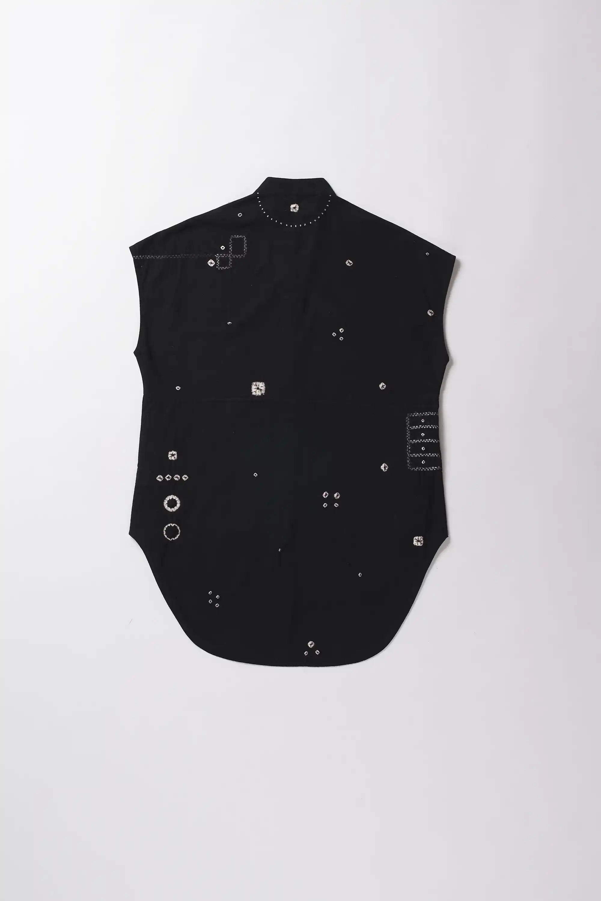Black sleeveless top with decorative elements on a white background