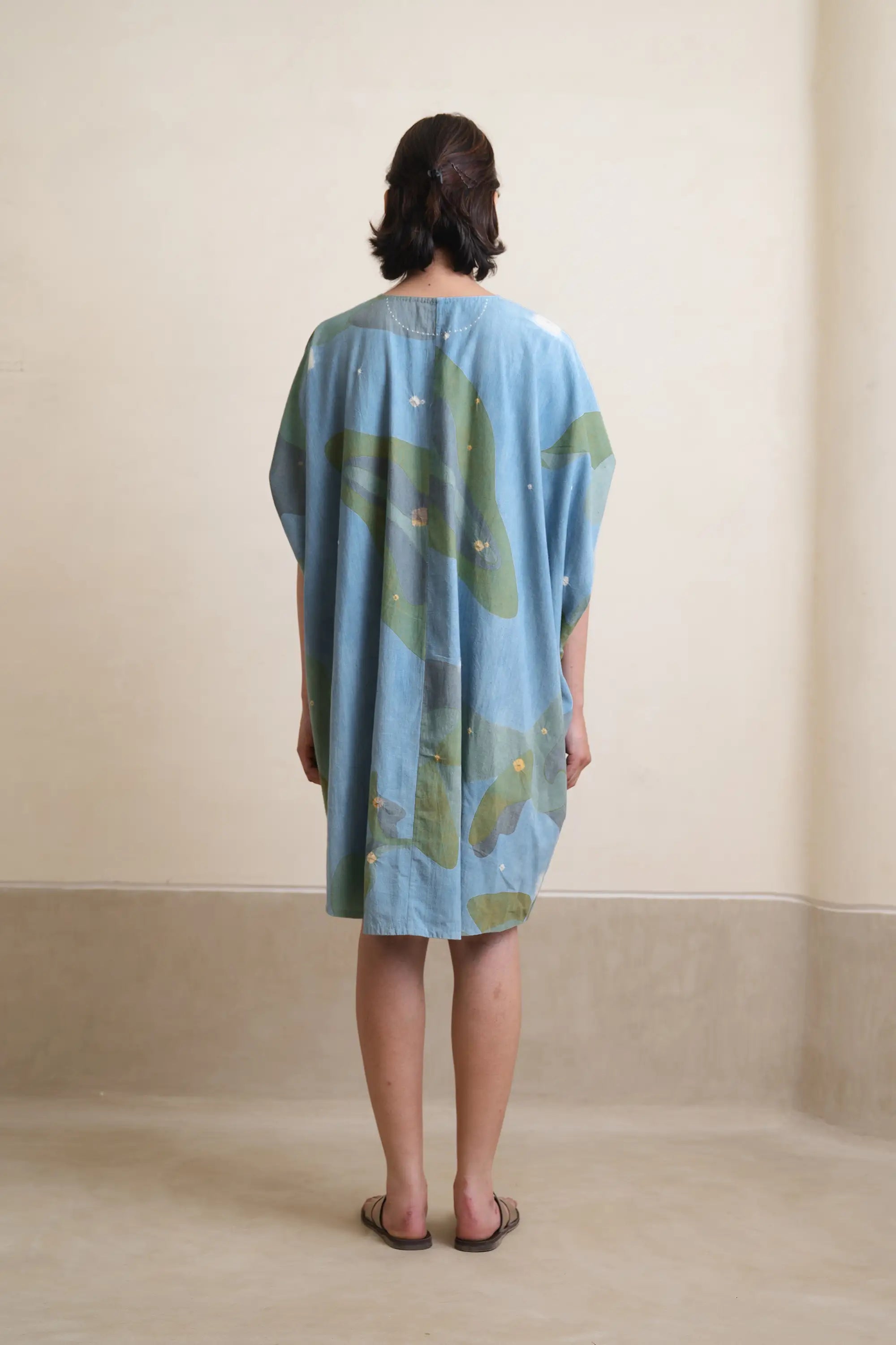 A back shot of woman wearing cotton sky indigo dress